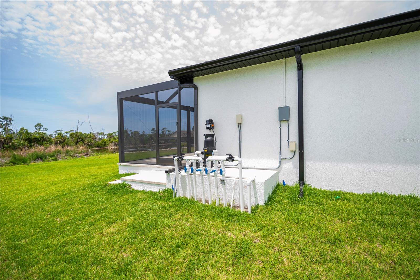 Exterior Utility Area Featuring Pool Equipment and Irrigation Controls. - 16692 LIGGETT CIR, PORT CHARLOTTE