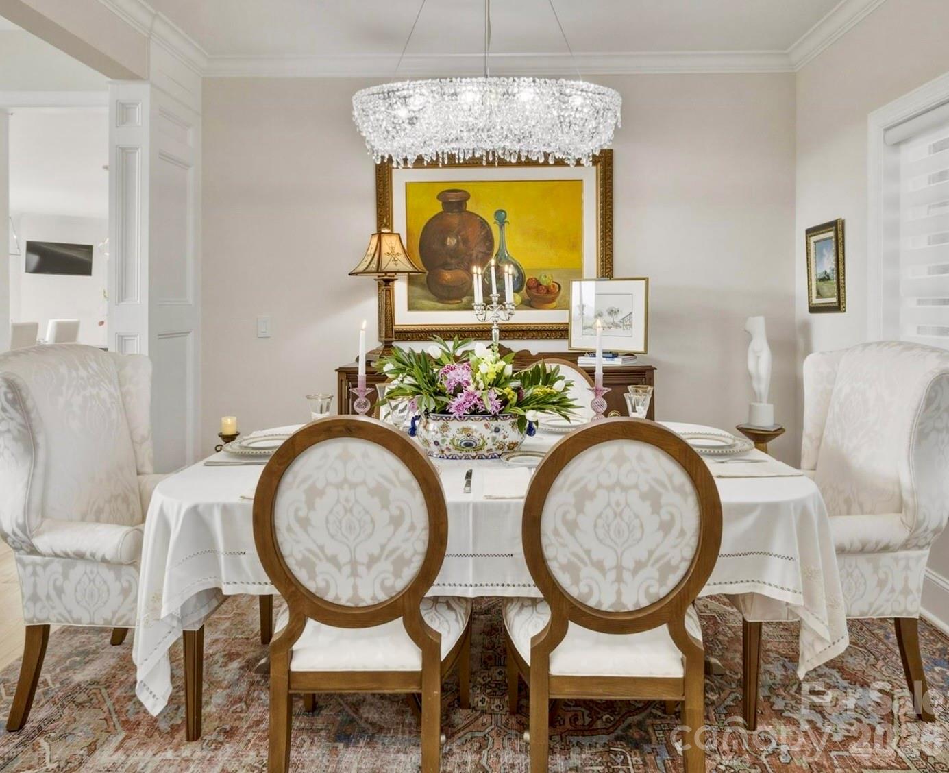 In the formal dining room, elegant architectural details complement the crystal chandelier’s brilliance. - 1506 High Valley Way, Lenoir
