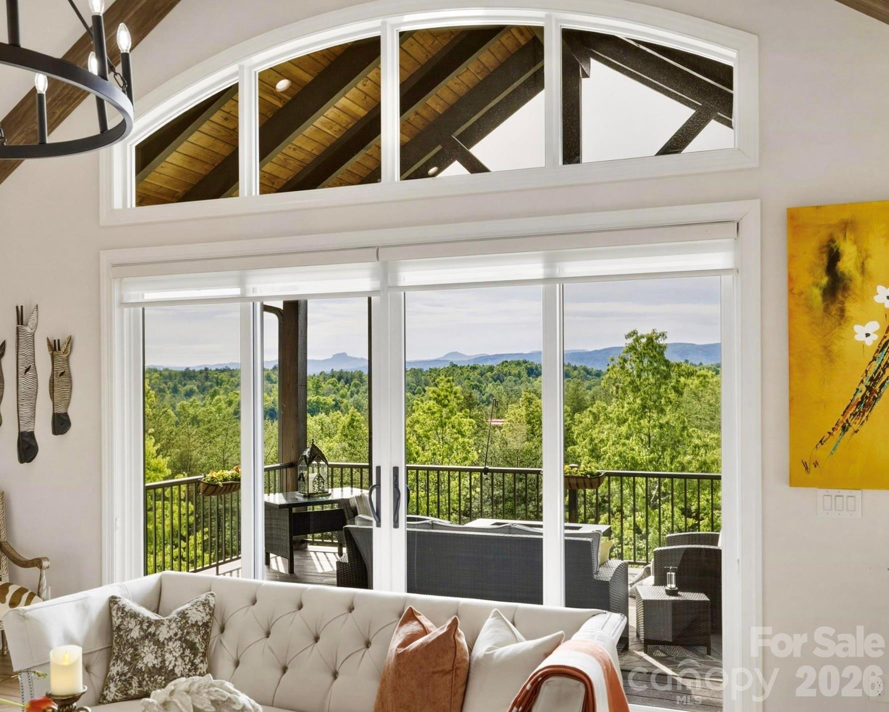 Spellbinding, layered long range mountain views include Table Rock, Brown Mountain, and more. A wide transom window crowns the space, bathing the interior in more soft, natural light. - 1506 High Valley Way, Lenoir