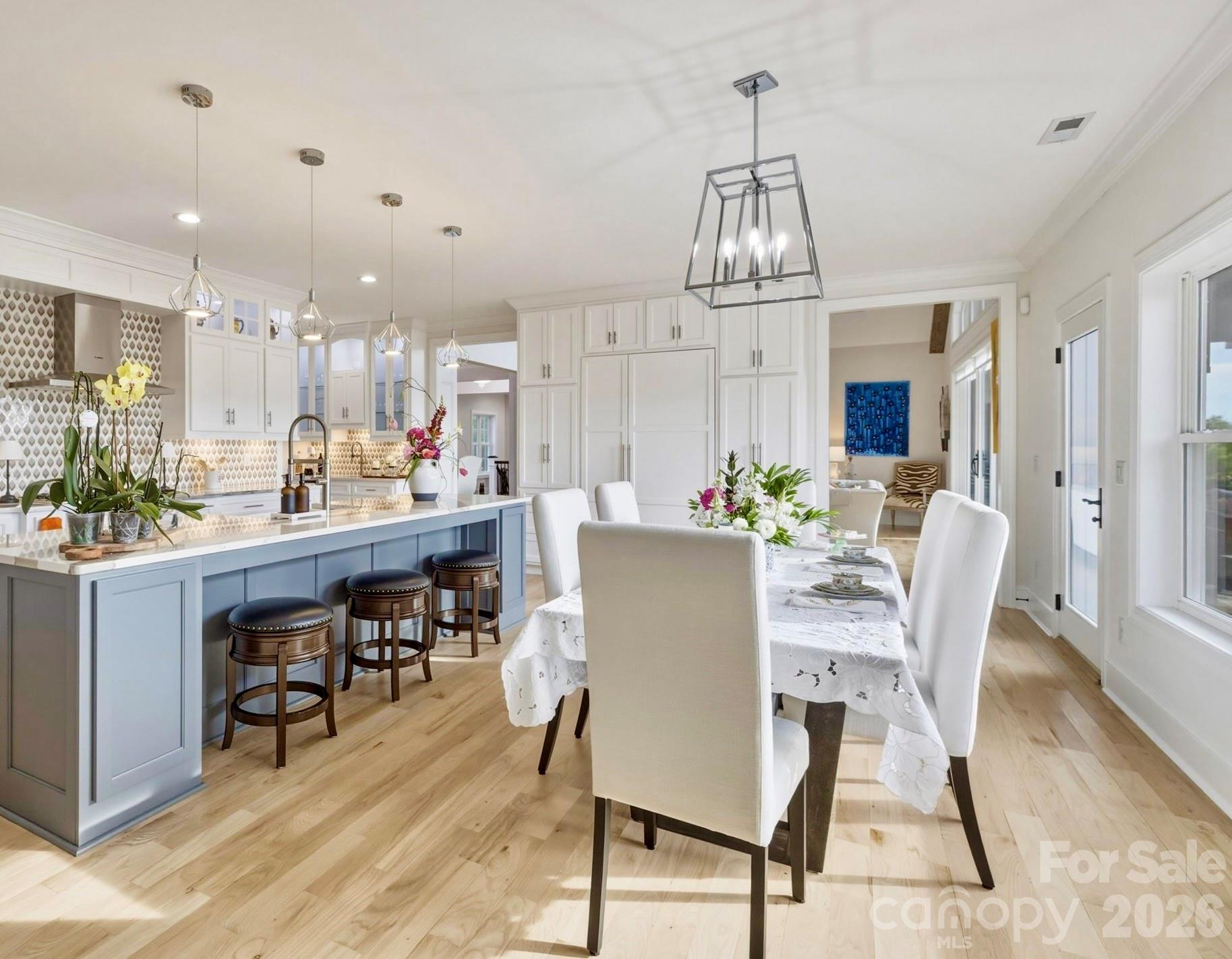 The eat-in dining space bathed in natural light with beautiful Blue Ridge Mountain views — the perfect spot for casual meals and memorable gatherings. - 1506 High Valley Way, Lenoir