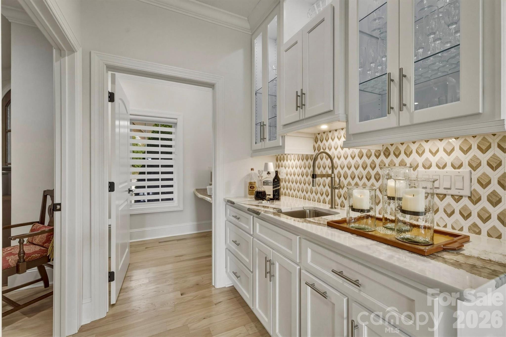 The kitchen wet bar is convenient AND beautiful with lighted glass door cabinets and Cambria quartz counter tops - 1506 High Valley Way, Lenoir
