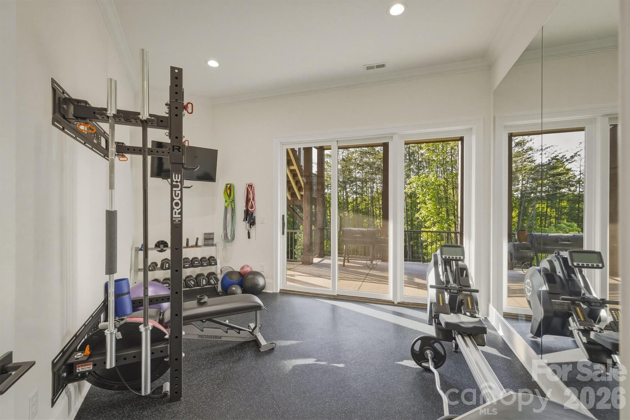 Exercise room with a wall of windows and a wall of mirrors - 1506 High Valley Way, Lenoir