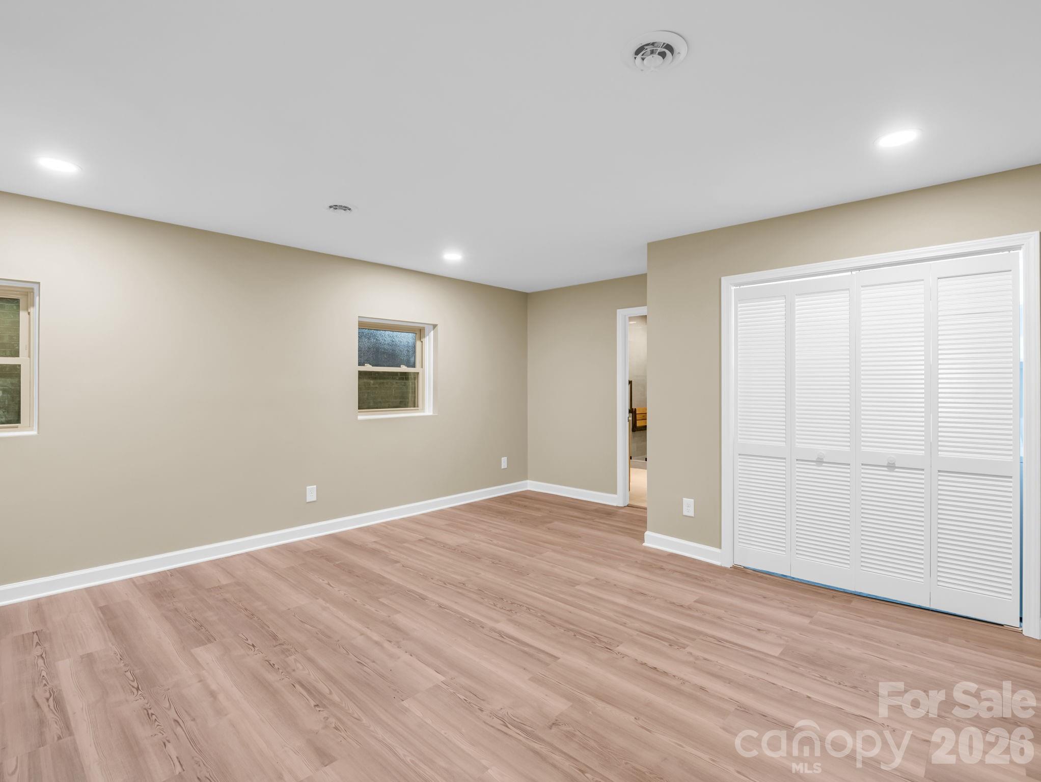Looking toward the primary ensuite bath, the closet door on the right is the laundry closet with full sized washer/dryer which also convey. - 44 Jervey Road, Tryon