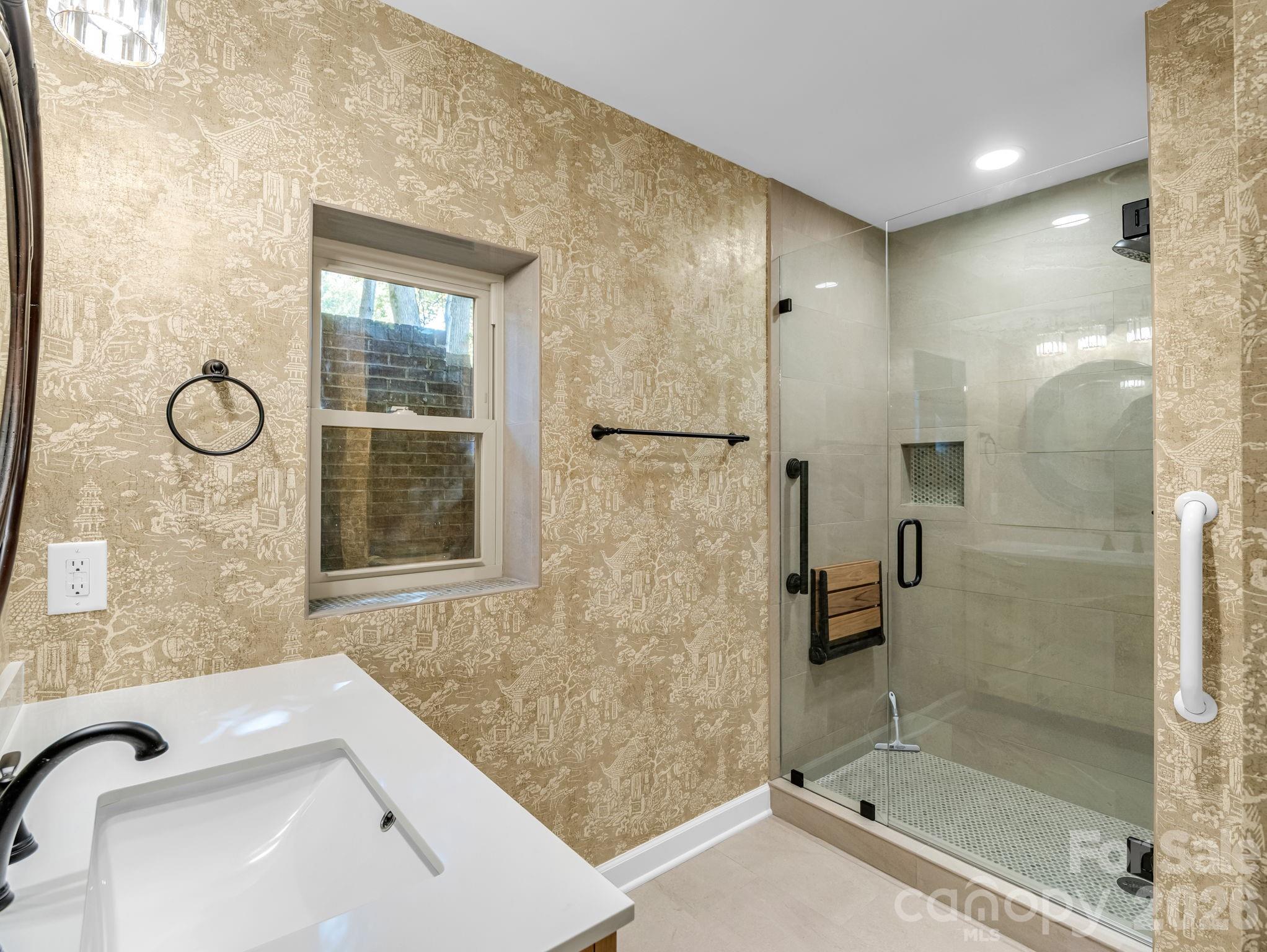 New shower with tile floor and walls, teak seat and custom glass door. - 44 Jervey Road, Tryon