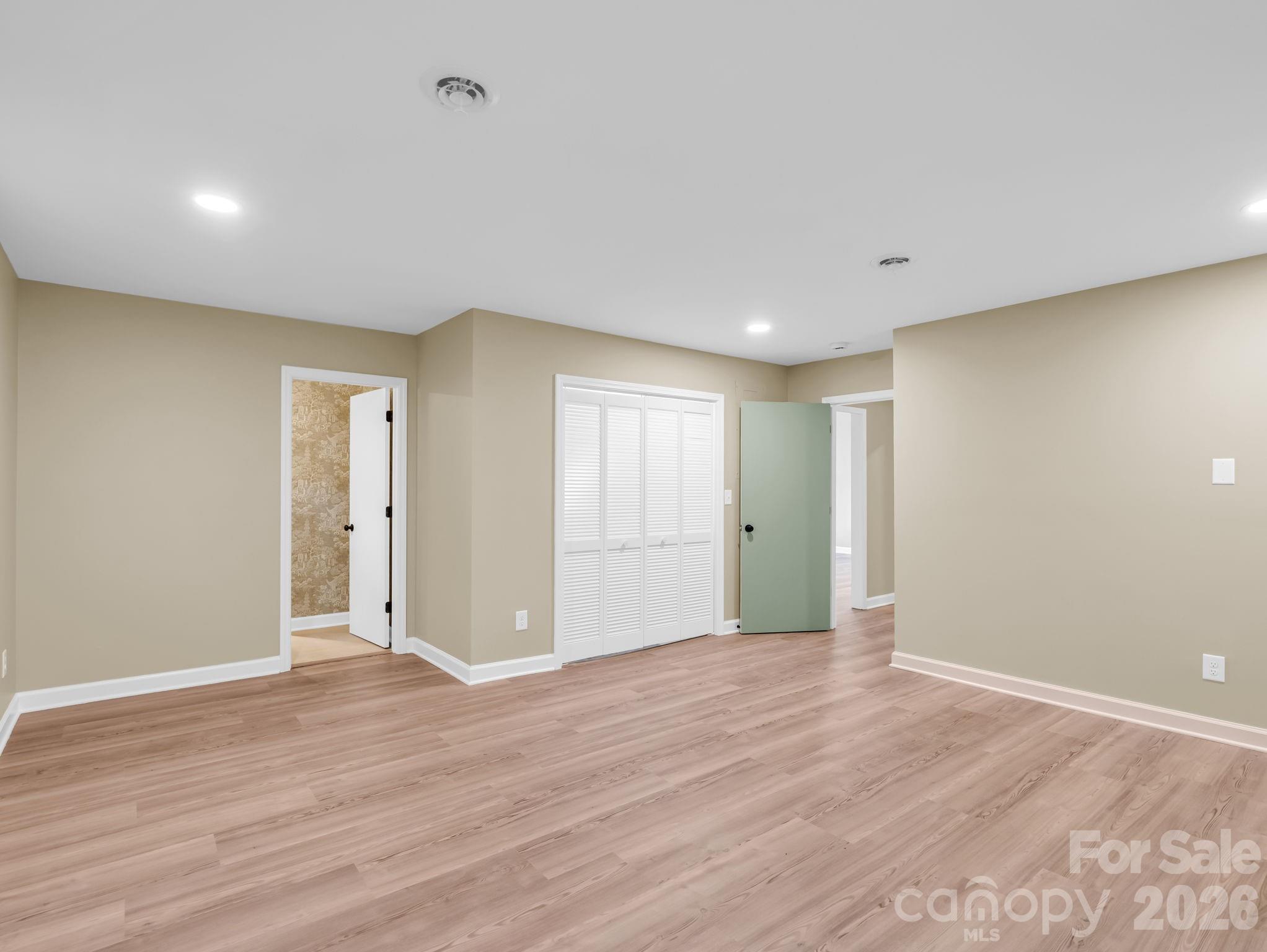 Primary bedroom looking back toward the the hallway, bathroom door on the left and laundry closet straight ahead. - 44 Jervey Road, Tryon