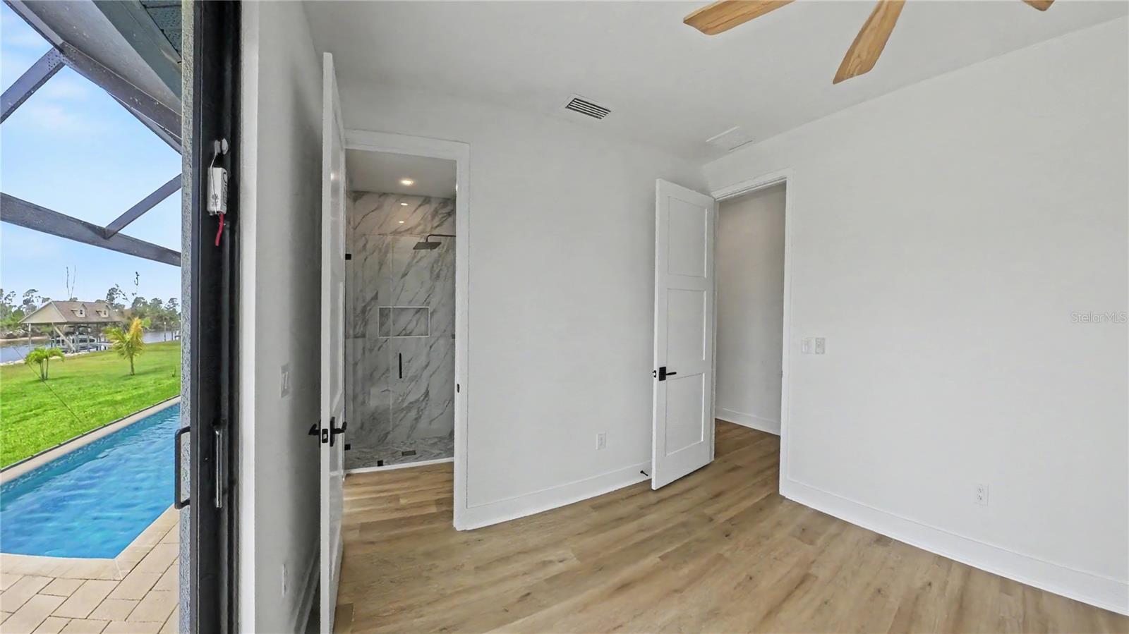 Bedroom 4 with Ensuite Bath and Pool Access. - 16692 LIGGETT CIR, PORT CHARLOTTE
