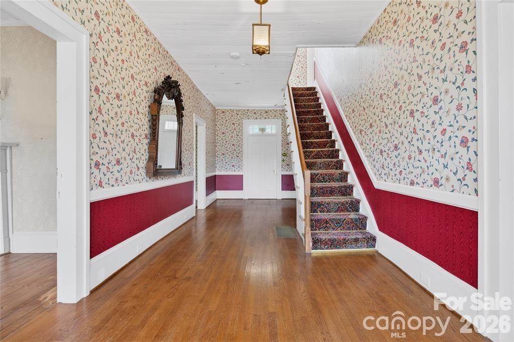 Grand entry into the center hall with original millwork an a door to the sunroom at the rear porch - 11124 Eastfield Road, Huntersville