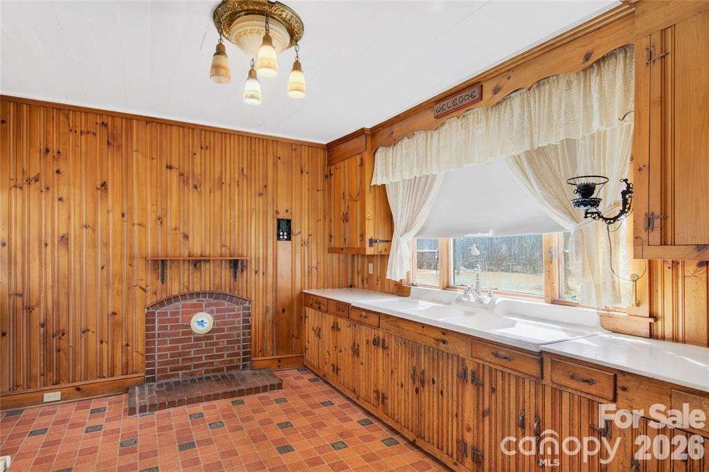 Kitchen has a masonry fireplace designed for a wood stove insert. - 11124 Eastfield Road, Huntersville