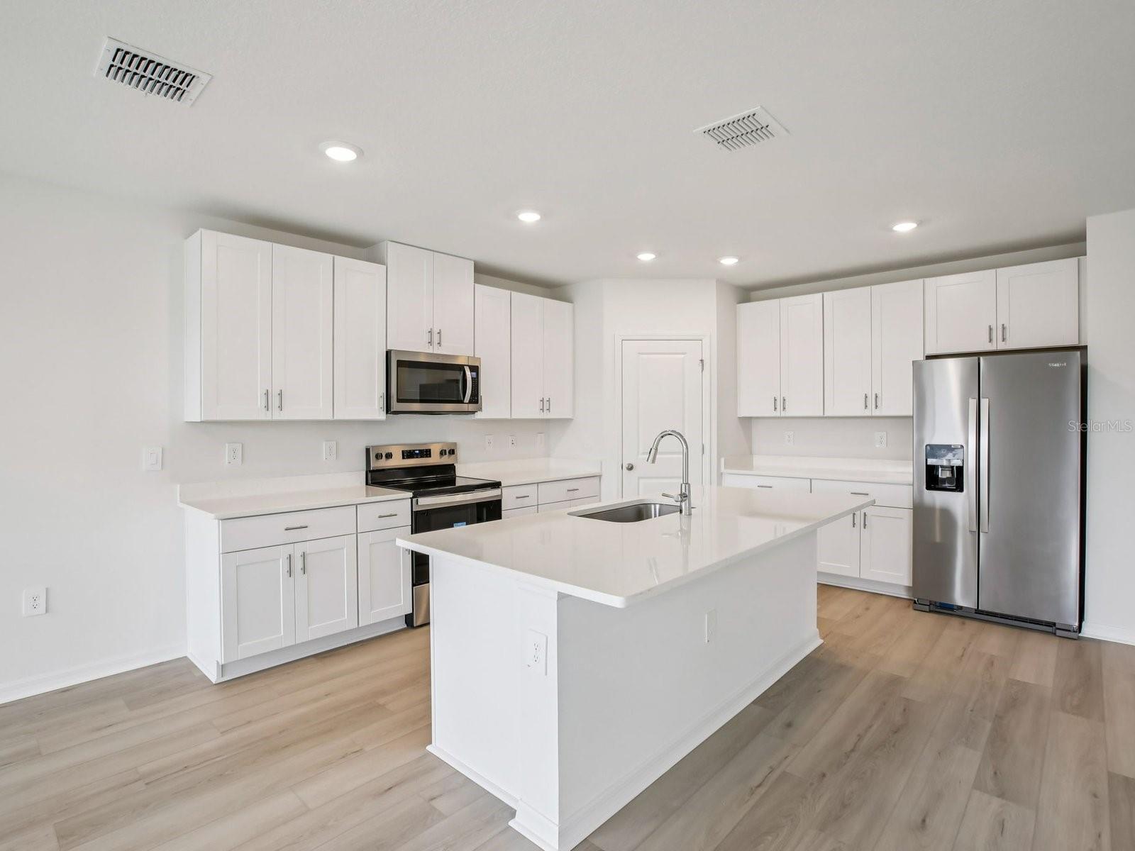 Interior photos are not of the actual home but are photos of the builder home with the same floorplan with similar interior finishes and features. - 10436 ABUNDANCE GROVE WAY, PARRISH