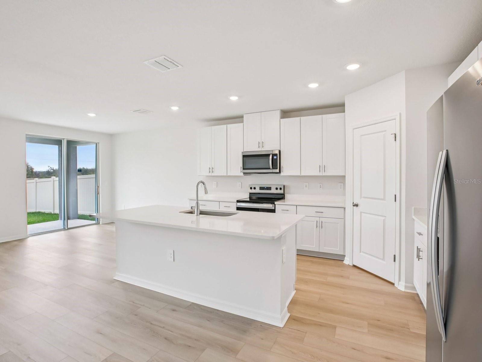 Interior photos are not of the actual home but are photos of the builder home with the same floorplan with similar interior finishes and features. - 10436 ABUNDANCE GROVE WAY, PARRISH