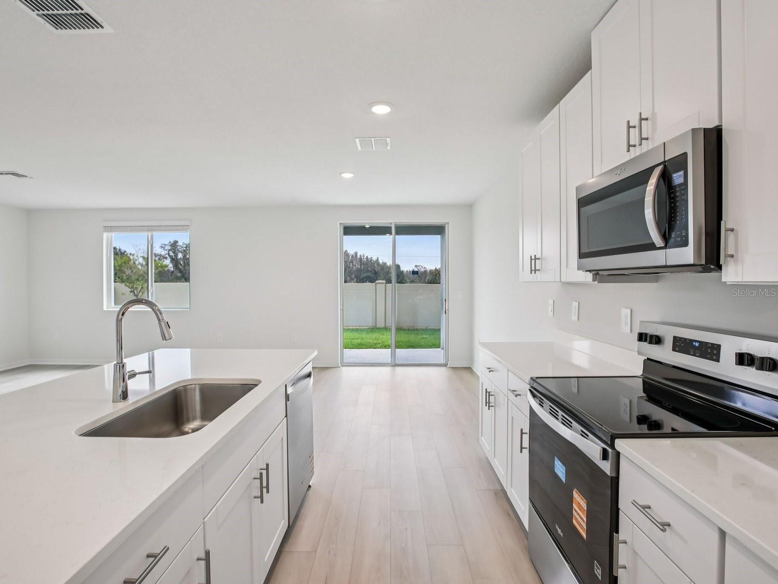 Interior photos are not of the actual home but are photos of the builder home with the same floorplan with similar interior finishes and features. - 10436 ABUNDANCE GROVE WAY, PARRISH