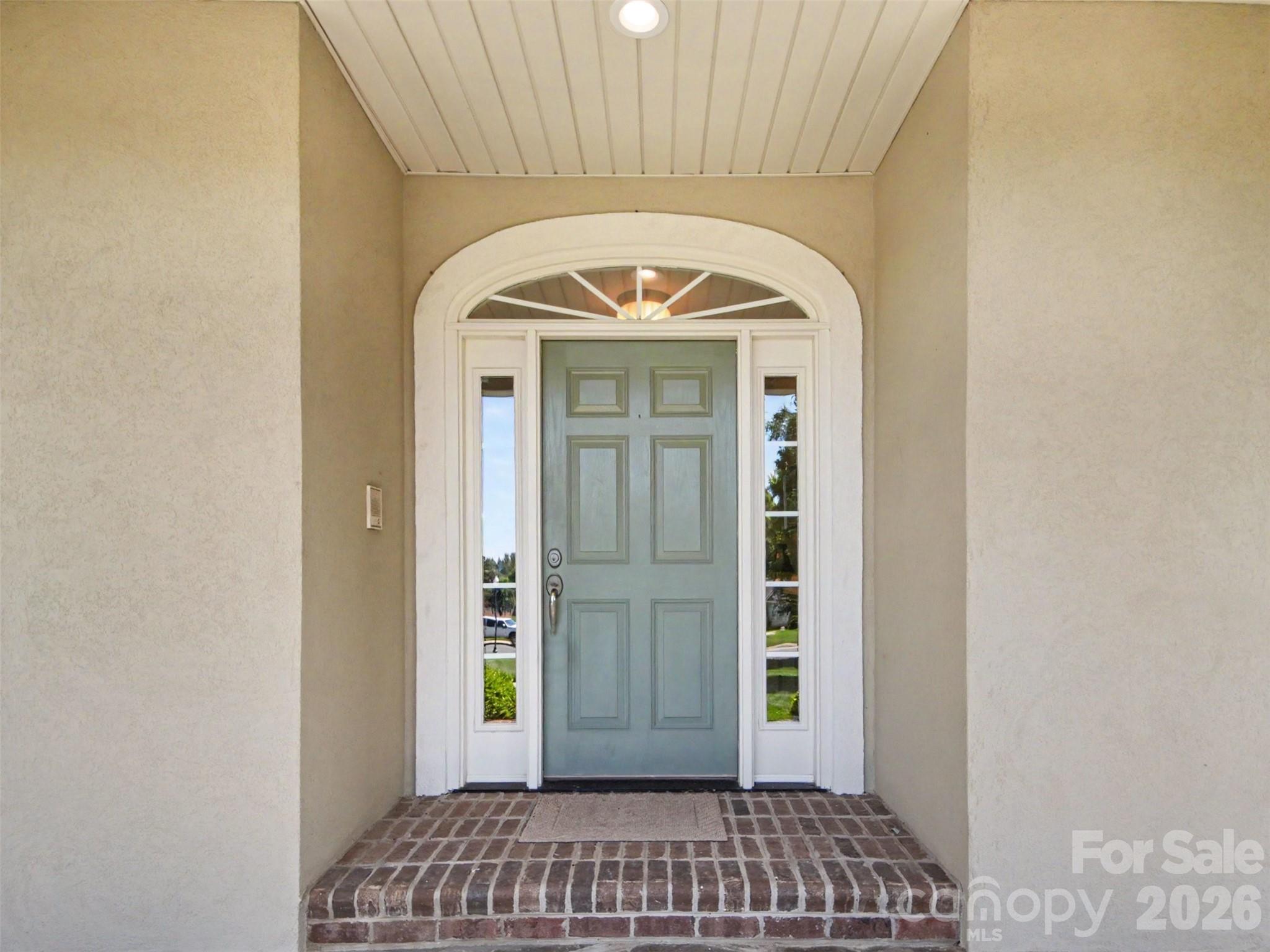 The front door with a beautiful arched casing is very inviting! - 1422 Stone Gate Drive, Shelby