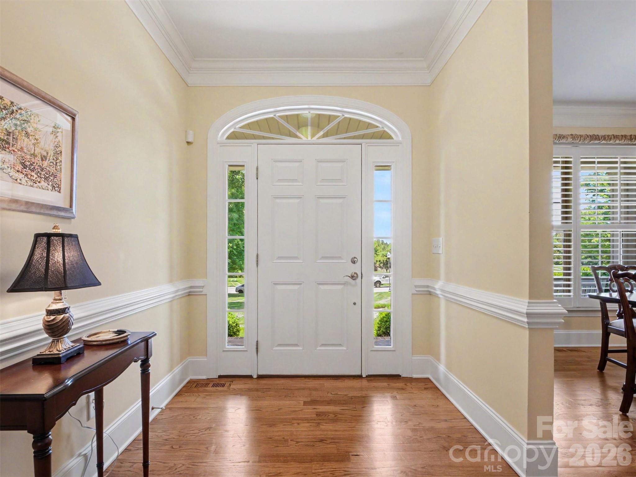 You enter into a wide foyer with thick molding and gleaming hardwood floors. - 1422 Stone Gate Drive, Shelby