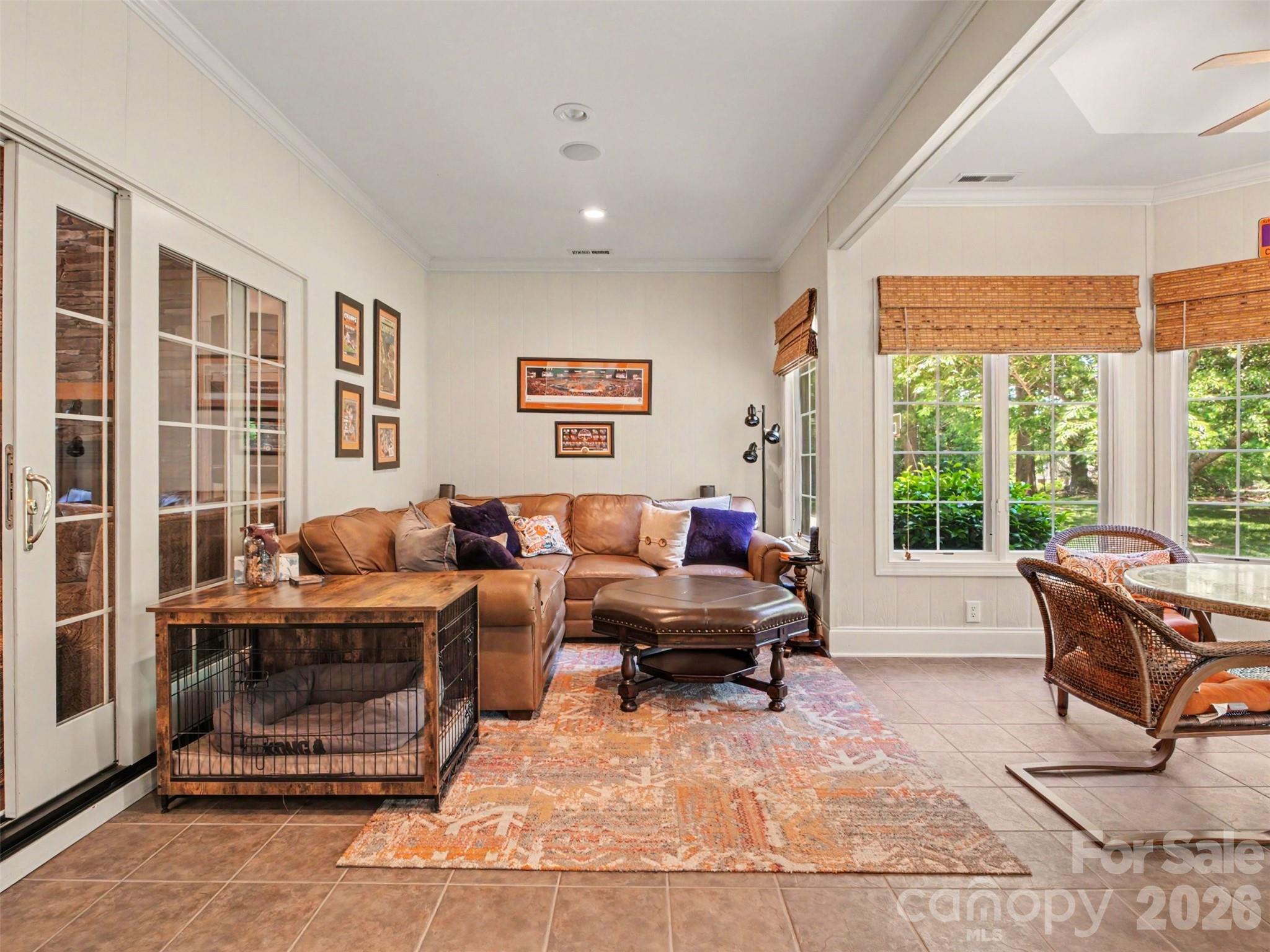 Sliding doors in the family room access the bright and airy sunroom...the perfect setting for morning coffee, reading, or casual gathering year-round. - 1422 Stone Gate Drive, Shelby