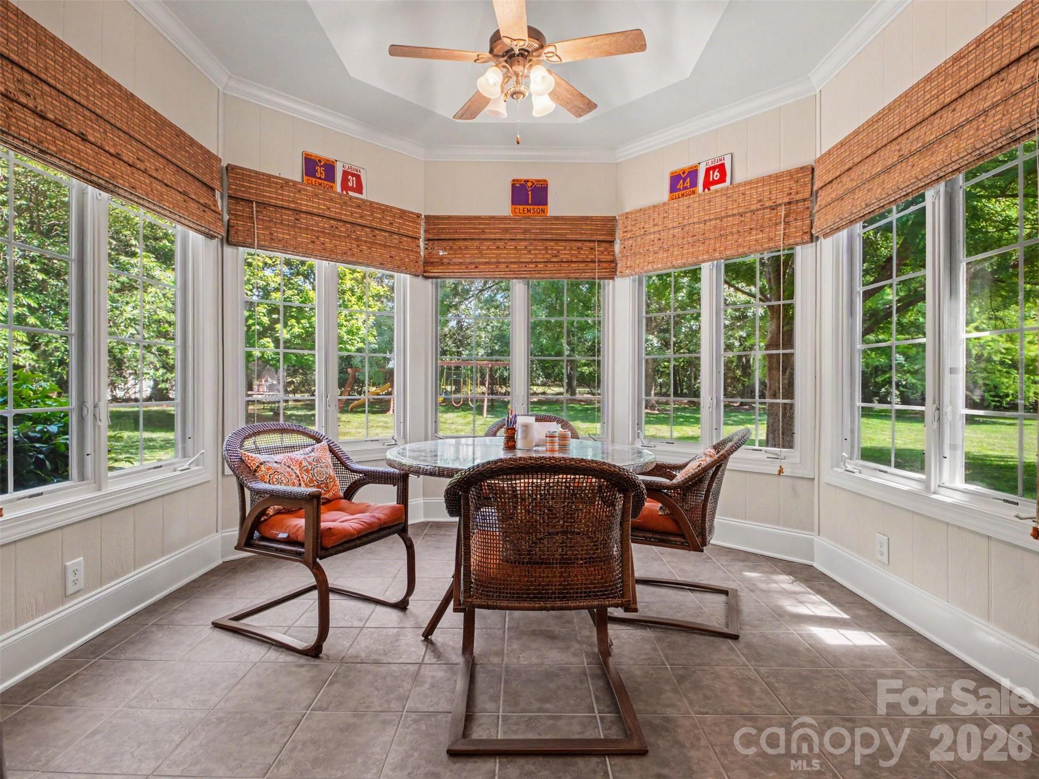 Windows surround the sunroom and fill the space with abundant natural light while offering relaxing views of the back yard. - 1422 Stone Gate Drive, Shelby