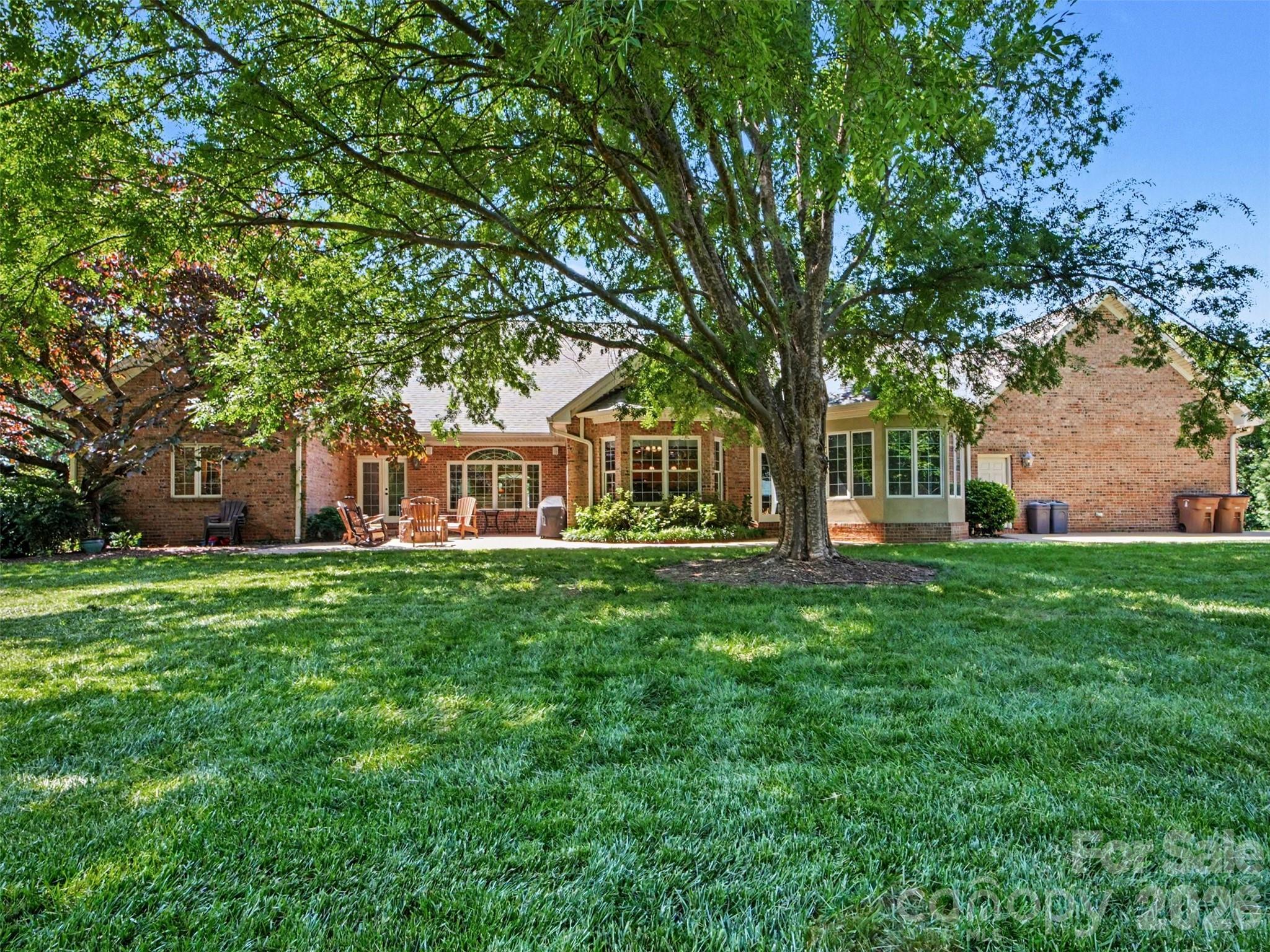 Patio with fire pit is accessed from primary bedroom, kitchen, and sunroom! Wonderful outdoor living area! - 1422 Stone Gate Drive, Shelby