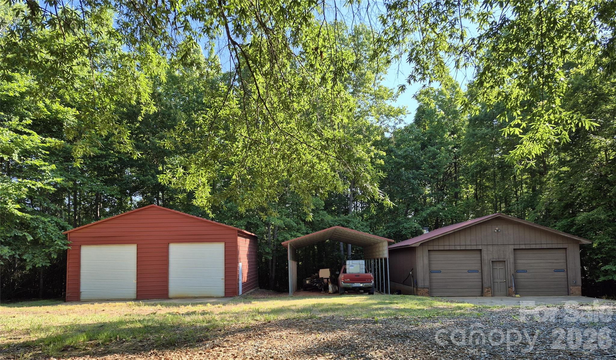 Steel garage with side entrance, detached carport, workshop with woodburning stove and bathroom. - 390 Low Water Bridge Road, Troy