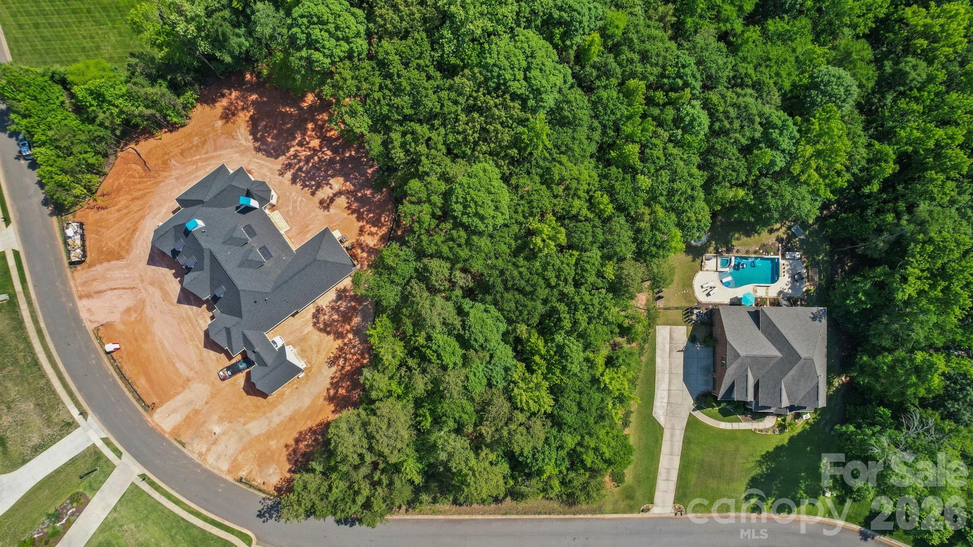 Property is the wooded area between the house under construction and the house with the pool. - 1235 Lancashire Drive, Fort Mill