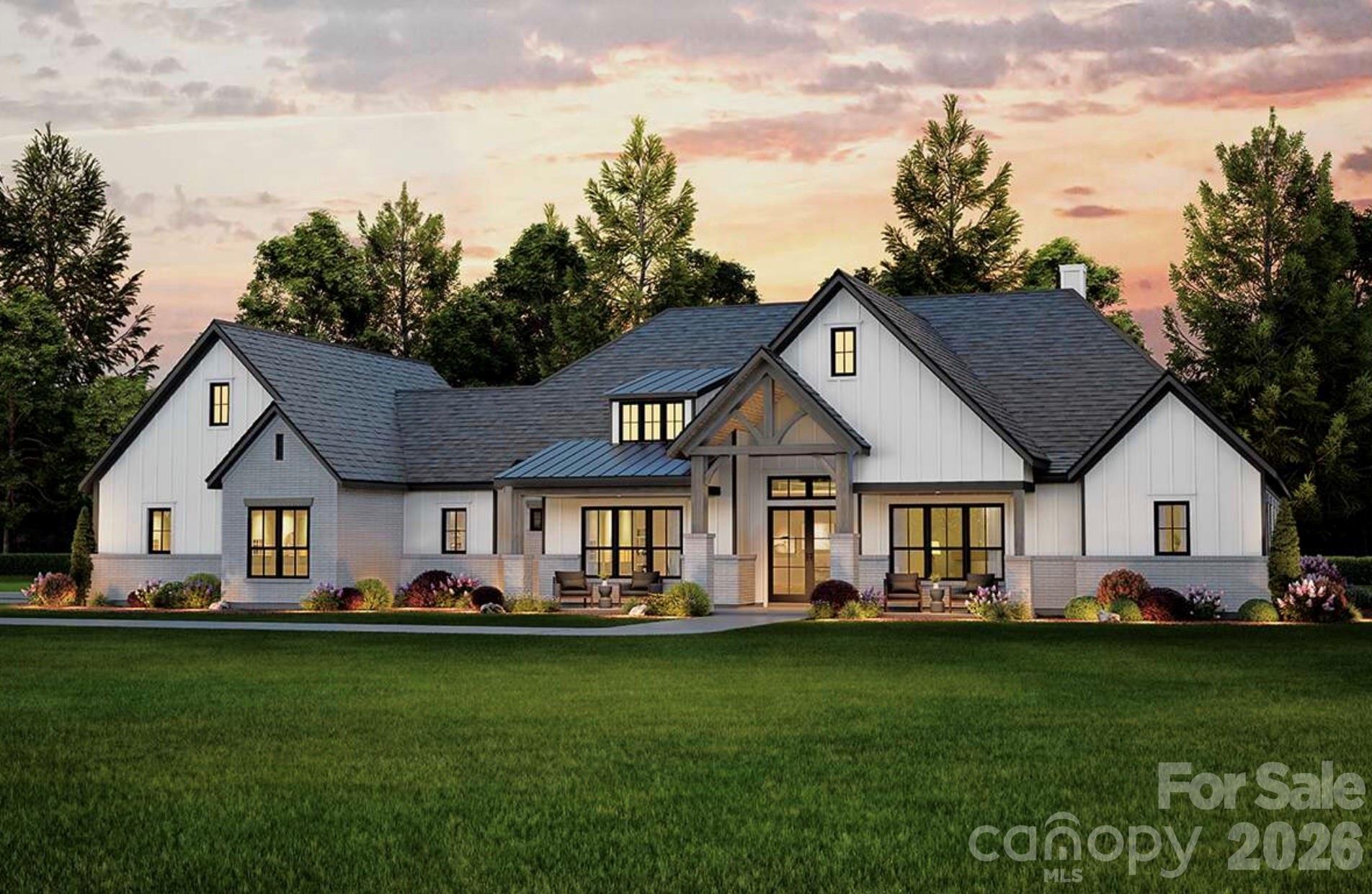This stunning modern farmhouse features a crisp white exterior with board-and-batten siding, contrasting dark trim, and a welcoming covered front porch accented by timber beams and brick columns. - Lot 4 Country Estates Drive, Waxhaw