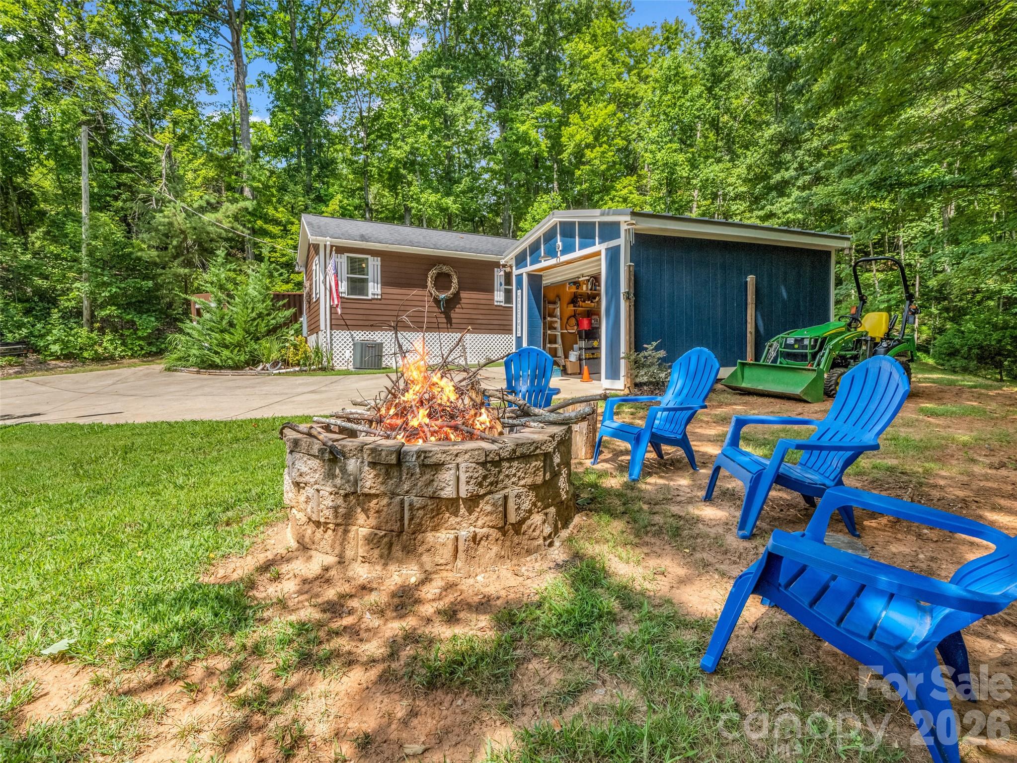 Firepit area featuring comfortable seating, ideal for evening gatherings and outdoor relaxation. - 479 Camp Hill Road, Lake Lure