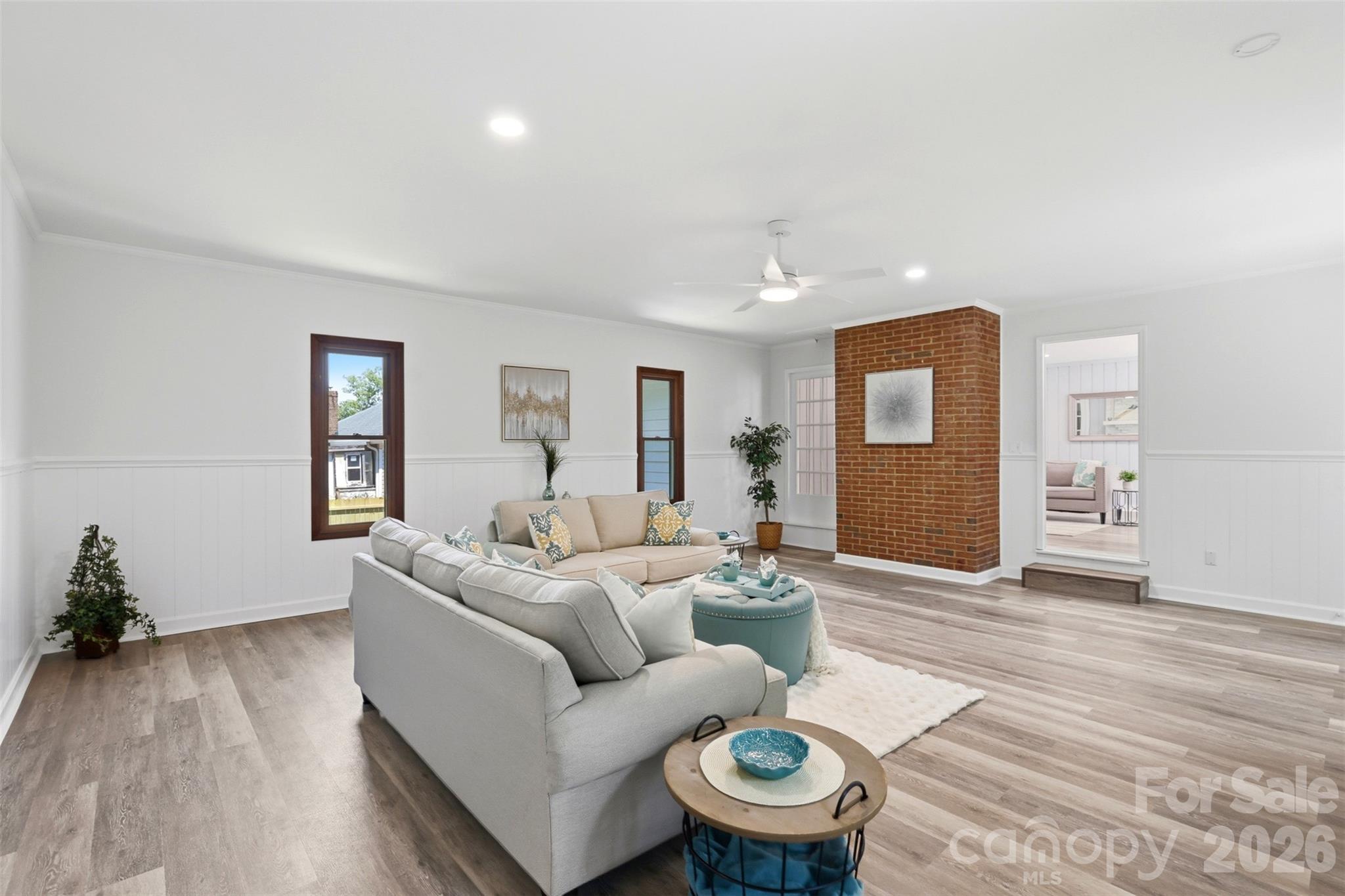This view reflects the rear of the working wood fireplace in the center of the home. One could place an electric fireplace here and use this exposed brick wall as a back drop. - 9624 Central Drive, Mint Hill