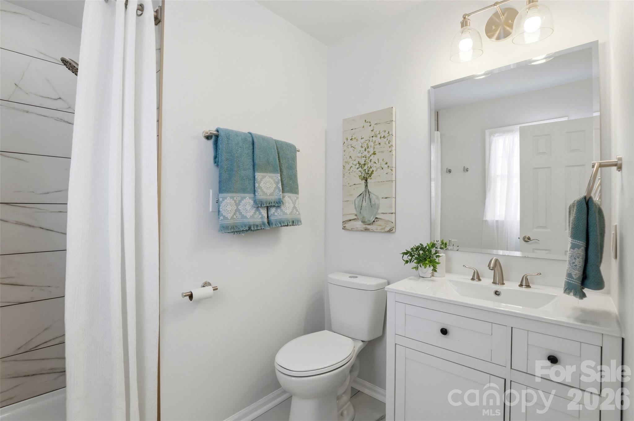 Primary bath boasts an updated vanity, lighting and gorgeous shower! - 9624 Central Drive, Mint Hill