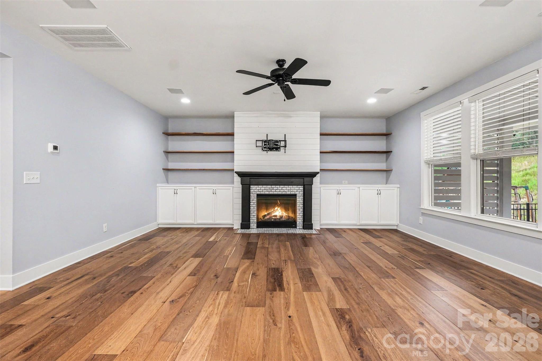 Living room with gas fireplace and built in shelves - 162 Stibbs Cross Road, Mooresville
