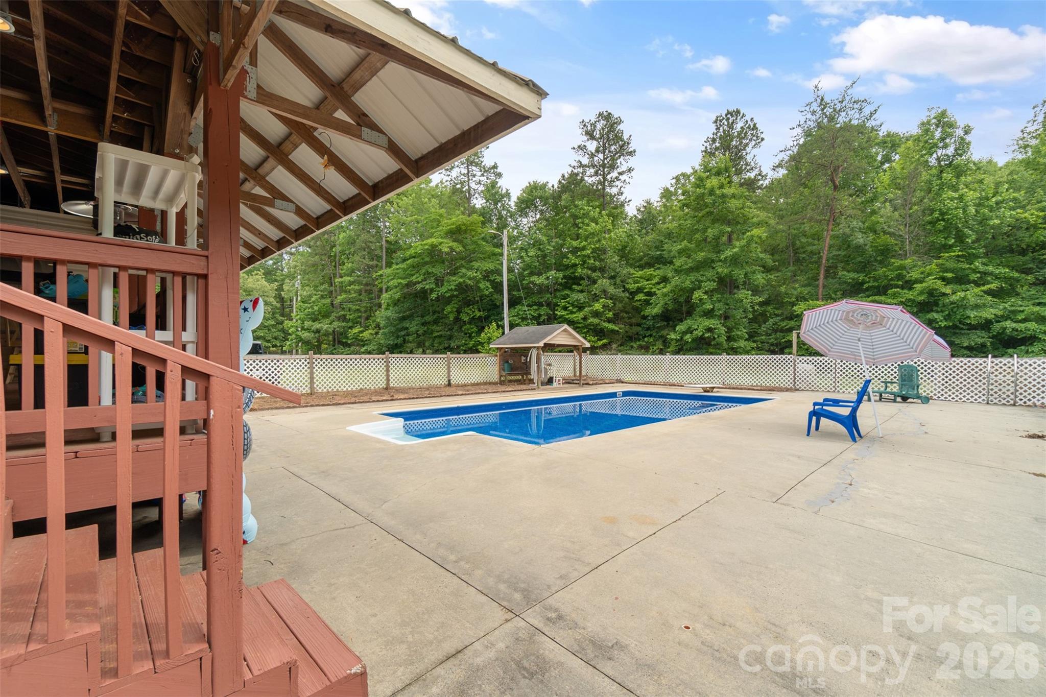 Covered back porch and pool view - 229 Oakridge Road, Stanley