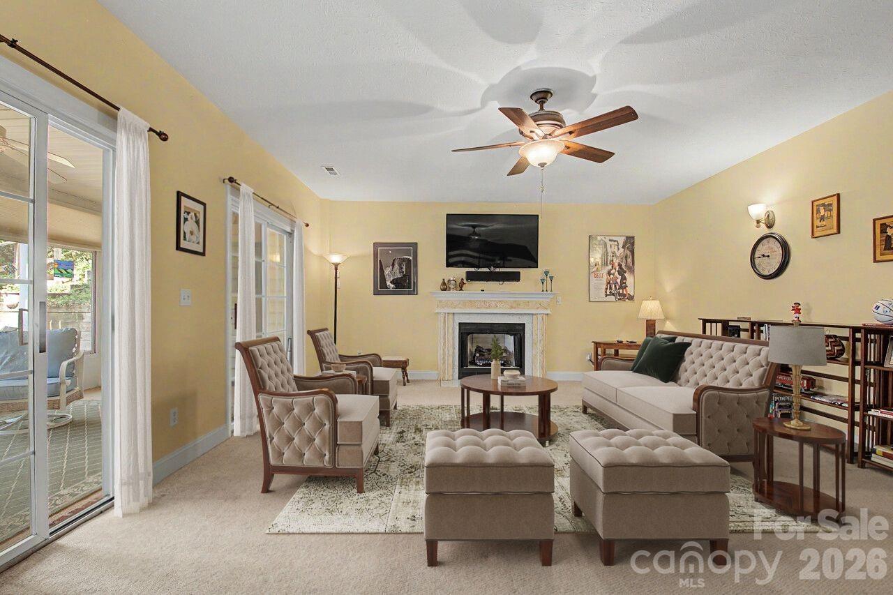 Virtually Staged Lower Level Family Room, Opens to second Sunroom - 606 Carriage Commons Drive, Hendersonville