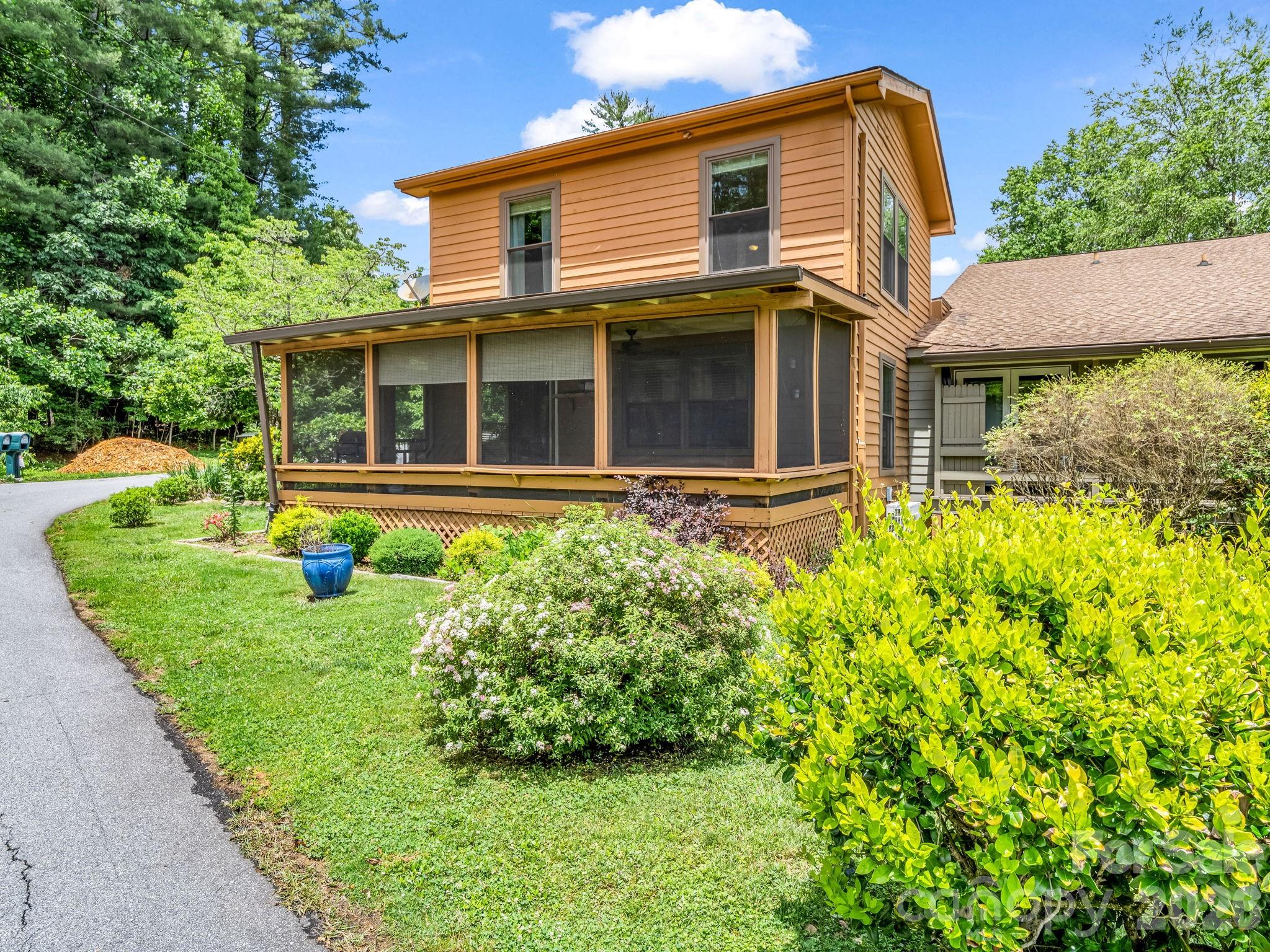 Side of the townhome showing the screened in porch. - 117 Willow Way, Hendersonville