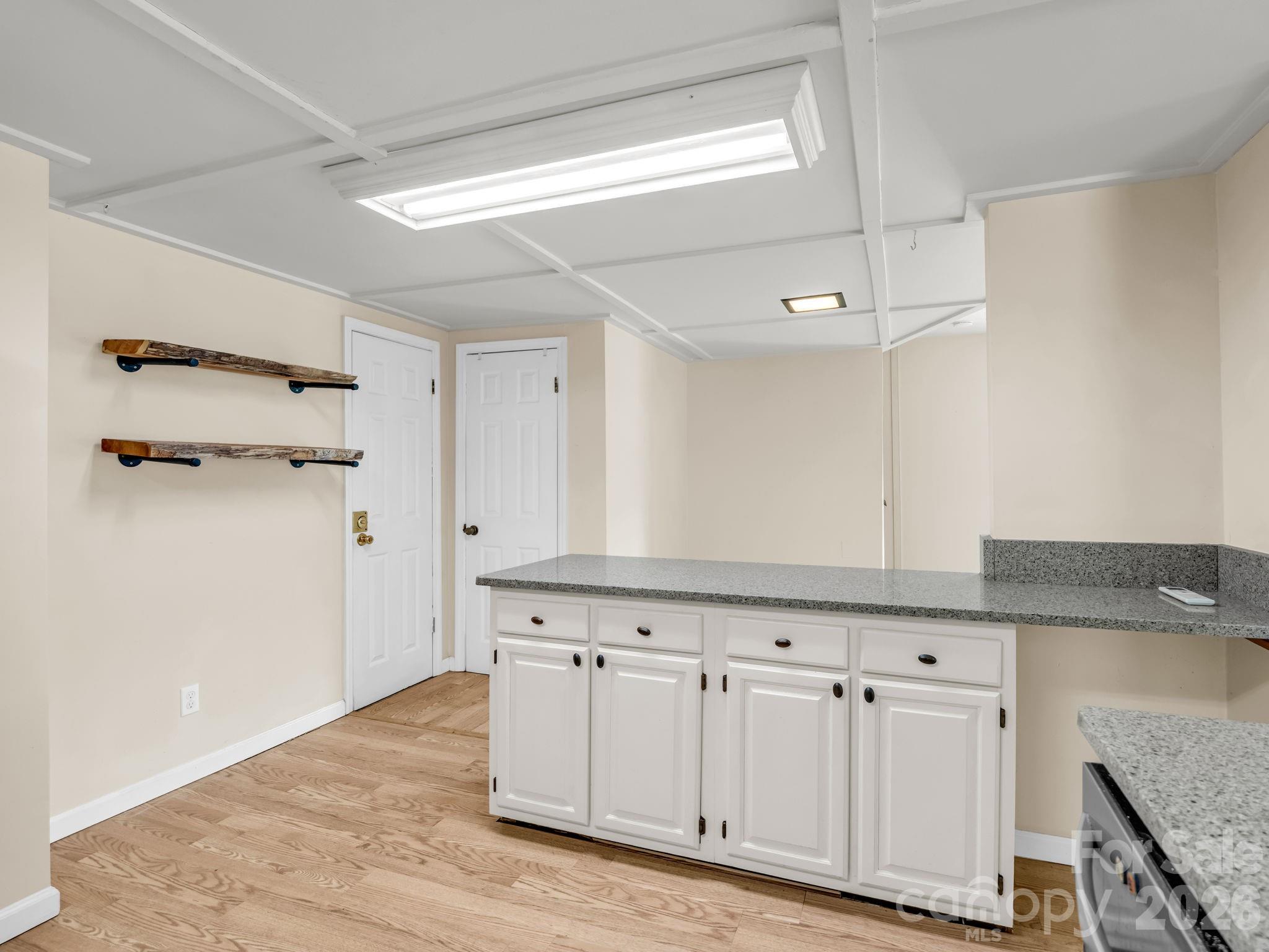 View from kitchen to living room, door to left leads to garage - 117 Willow Way, Hendersonville
