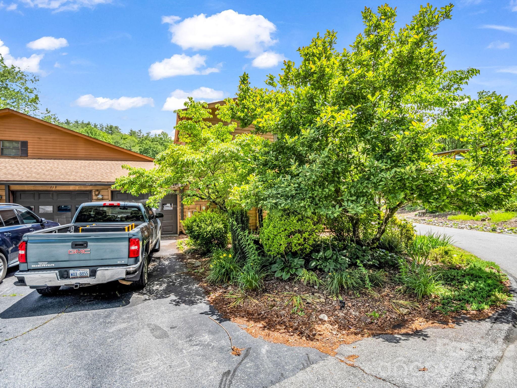 View of driveway looking at garage - 117 Willow Way, Hendersonville