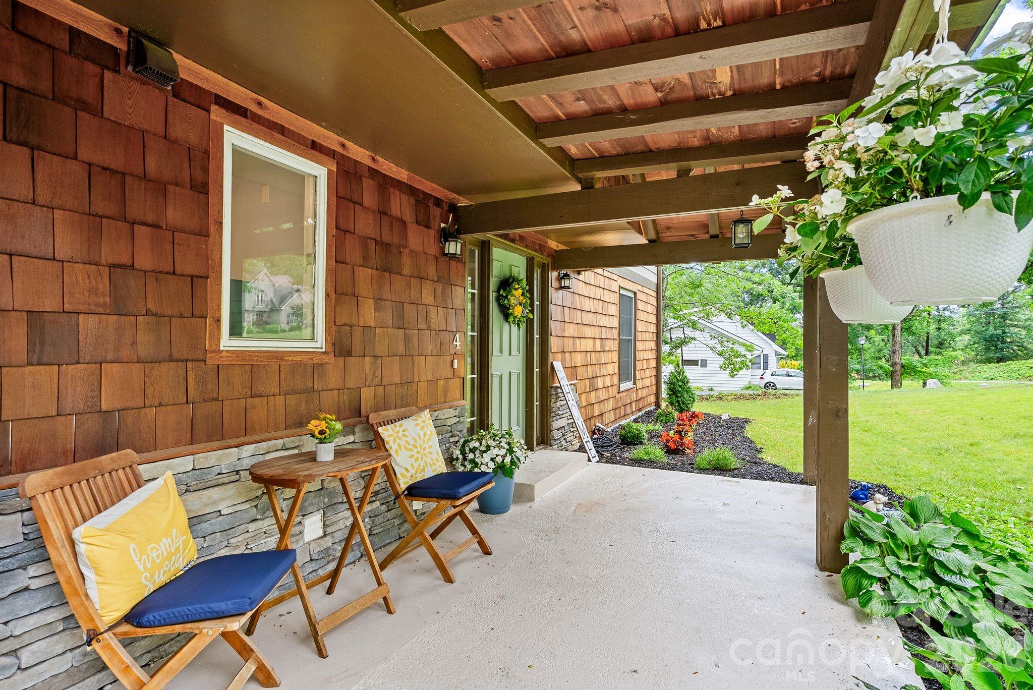 Enjoy coffee on the charming covered front porch. - 4 Beechwood Lakes Drive, Hendersonville