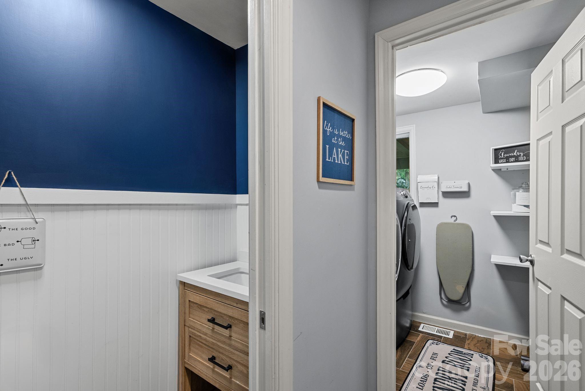 View of powder room and laundry room in hall off garage. - 4 Beechwood Lakes Drive, Hendersonville