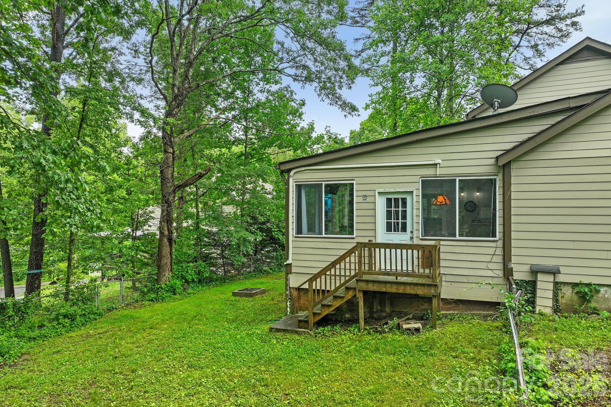 Step outside the sunroom and step into your fenced back yard with firepit. - 4 Beechwood Lakes Drive, Hendersonville
