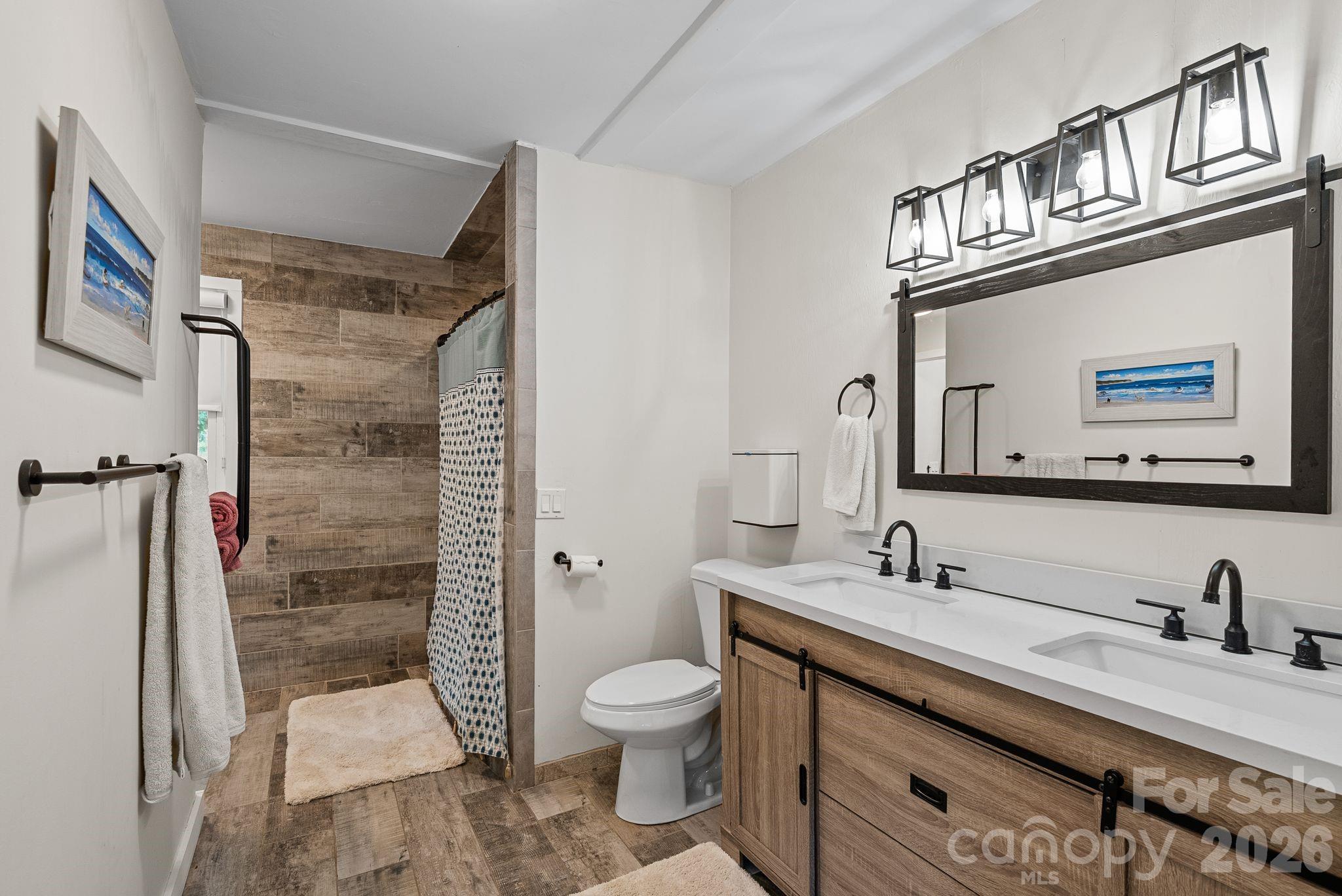 The primary bath features double sink and spa shower. - 4 Beechwood Lakes Drive, Hendersonville