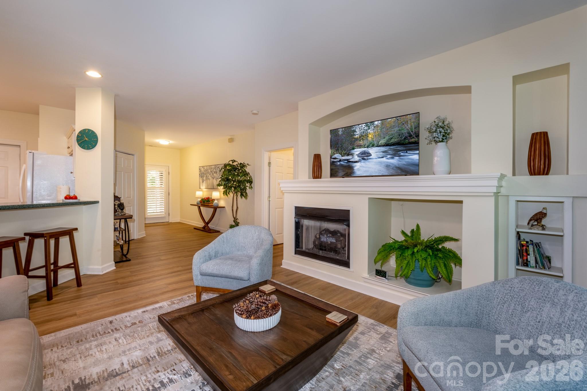 Open Living Area – Inviting open-concept living space with fireplace focal point, abundant natural light, and an easy flow to the kitchen and foyer. - 99 Ridgetop Circle, Brevard