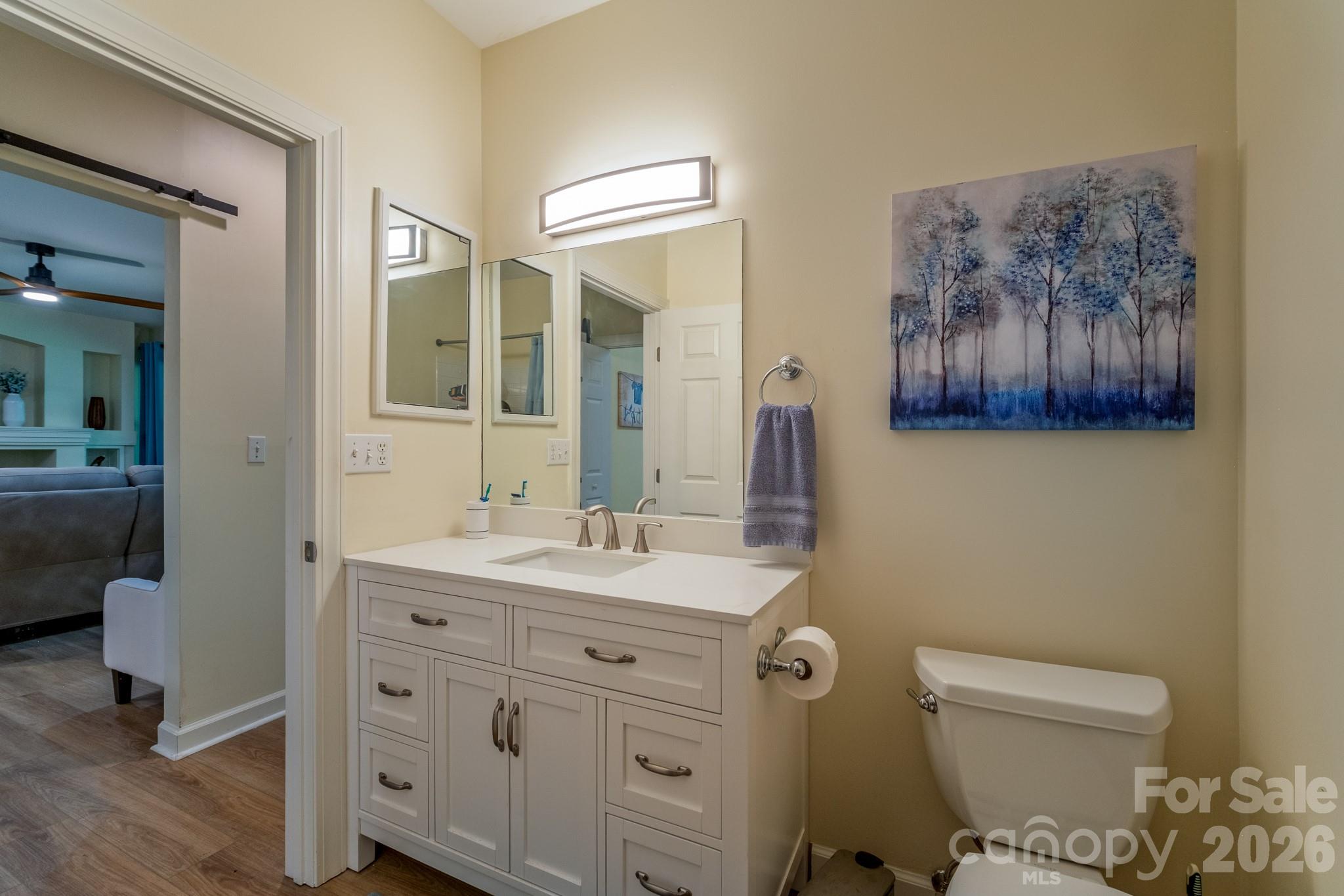 Updated Bathroom Vanity – Updated bathroom with stylish vanity, modern lighting, and direct access from the main living area and guest spaces. - 99 Ridgetop Circle, Brevard
