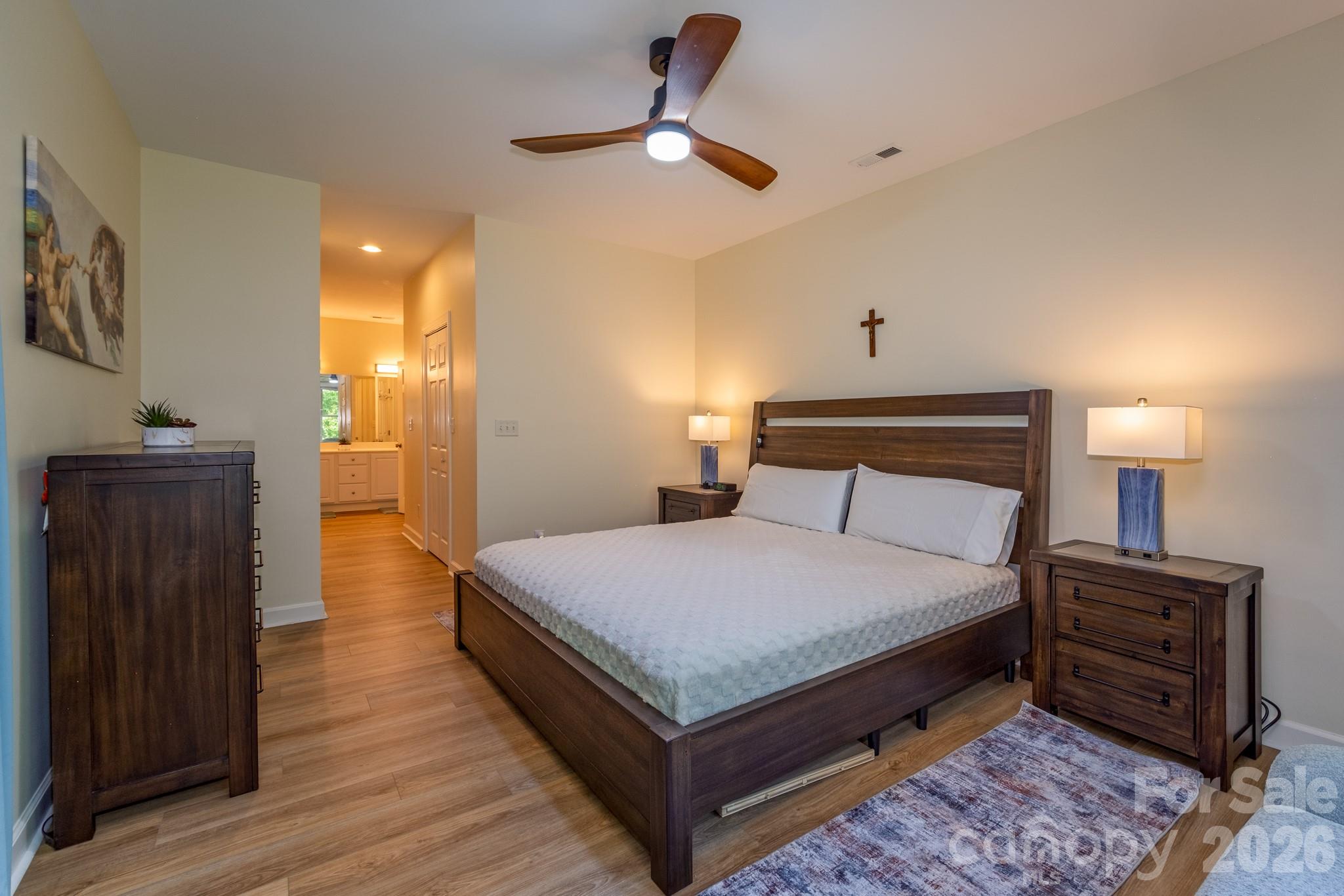 Spacious Primary Suite – Generously sized primary bedroom featuring ample space for furnishings, warm natural light, and easy access to the en-suite bath. - 99 Ridgetop Circle, Brevard
