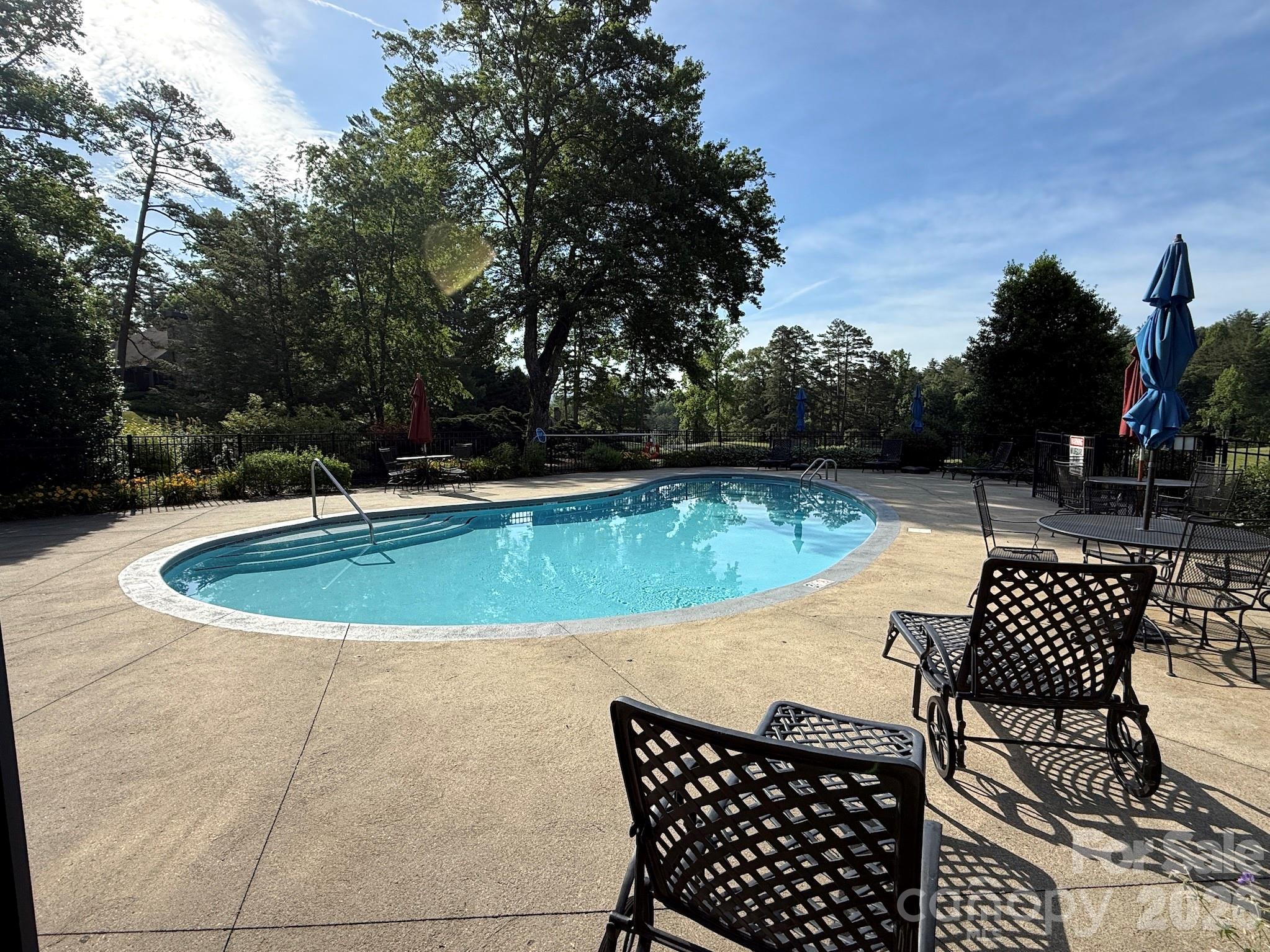 Community Pool – Enjoy warm summer days at the community pool, complete with lounge seating and a relaxing setting surrounded by mature landscaping and mountain air. - 99 Ridgetop Circle, Brevard