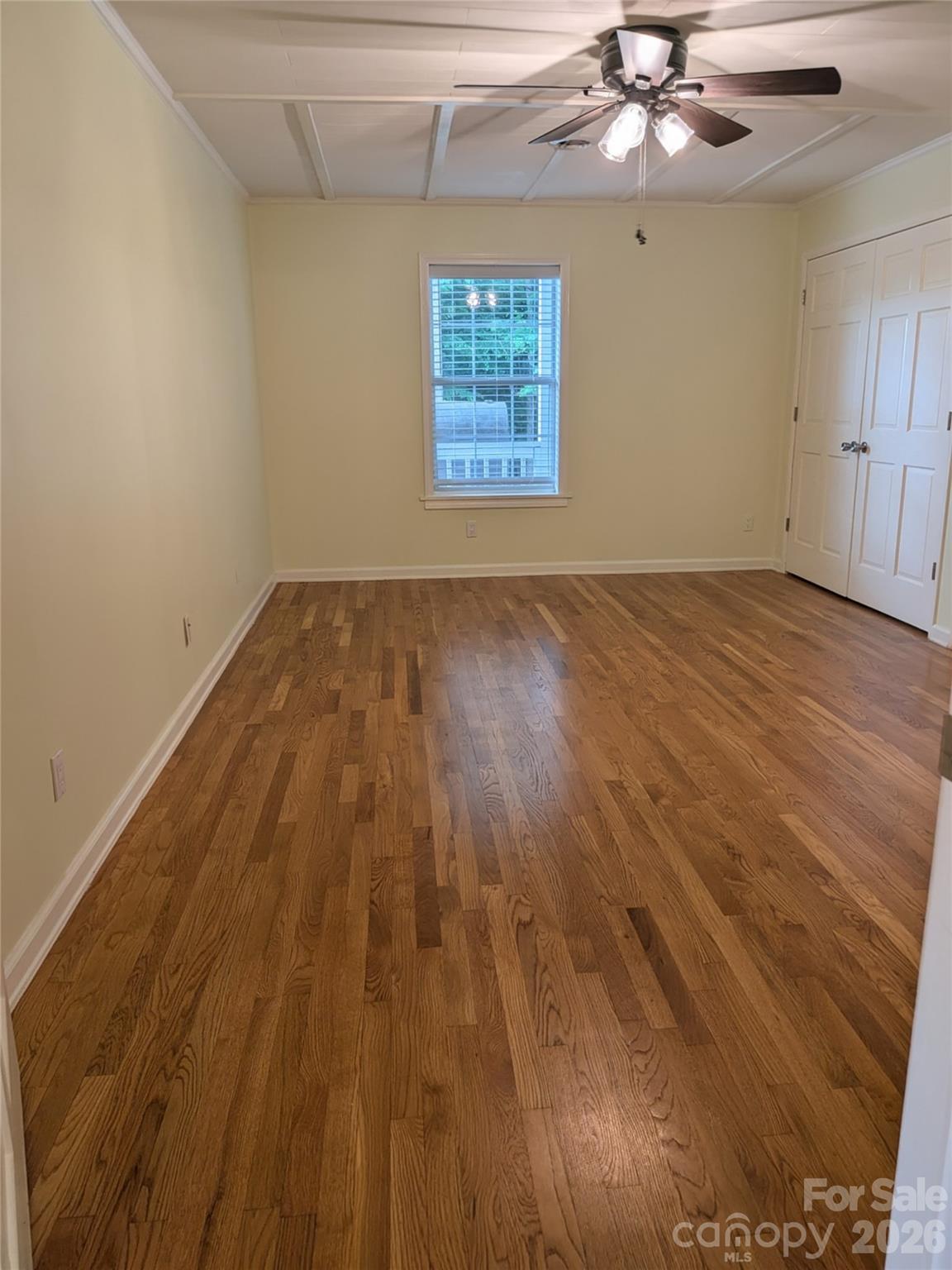 Spacious primary bedroom with an entire wall of closet space. - 59 Ck Cabin Drive, Hot Springs
