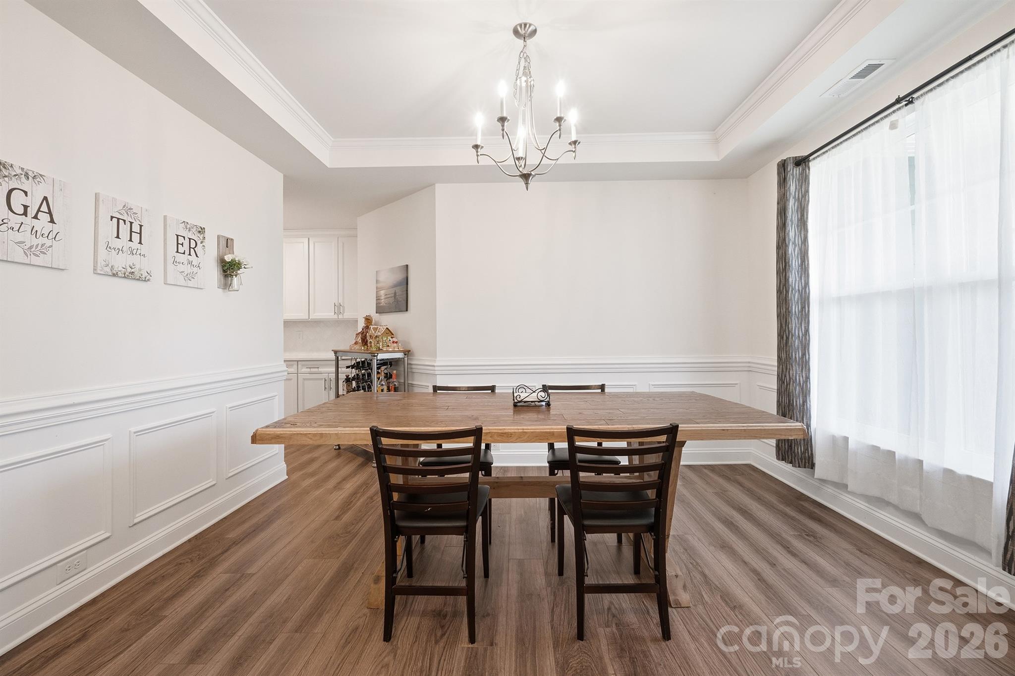 Dining Room Featuring Tray Ceilings and Wainscoting - 282 Bouchard Drive, Waxhaw