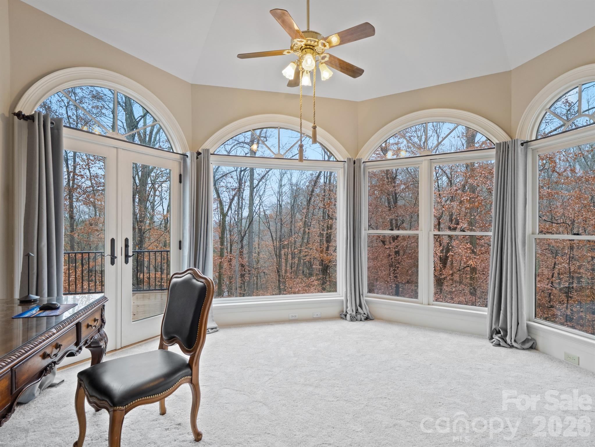 From the sitting area in the primary bedroom, peaceful views of water and trees greet you each morning. - 1090 N Saunders Drive, Catawba