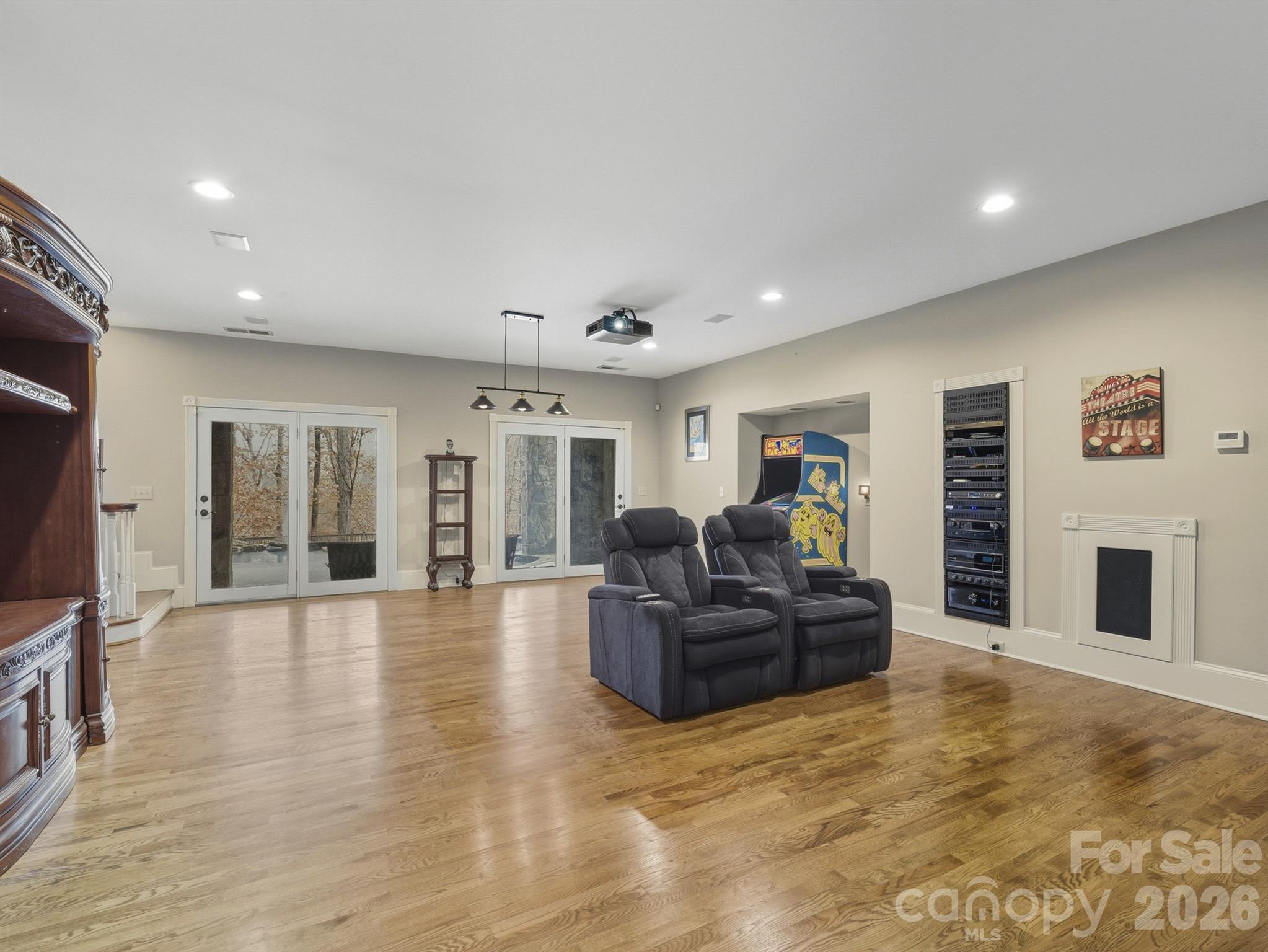 A projection screen lowers to transform the room into a private cinema. The sound system is exceptional, consistently recognized for its outstanding quality. - 1090 N Saunders Drive, Catawba