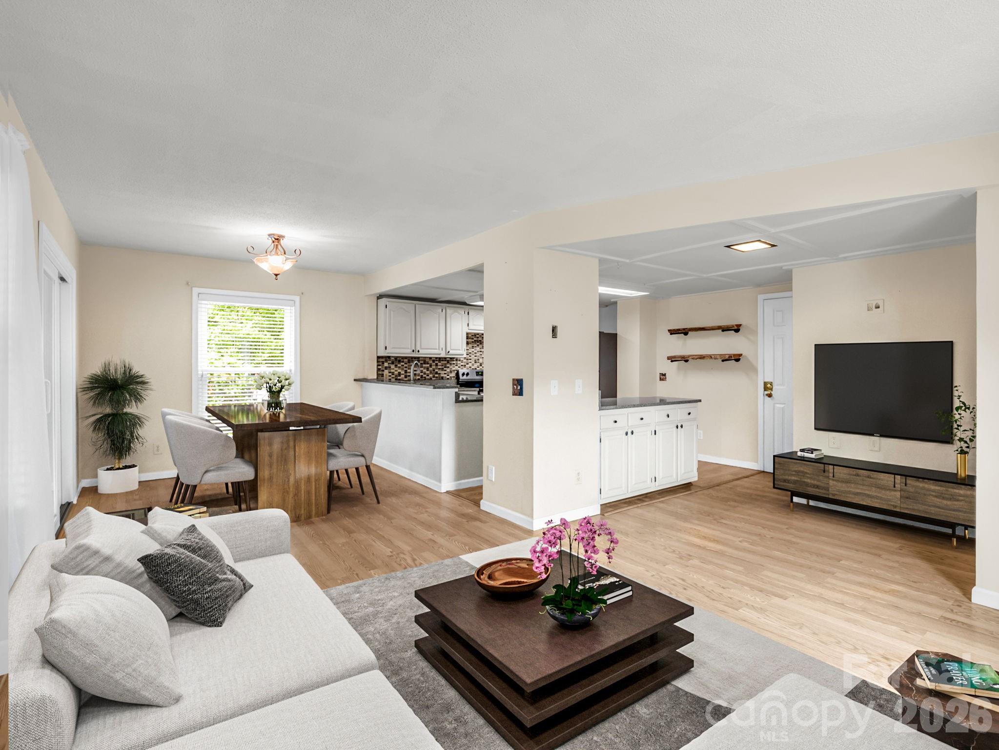 Virtual staging - Open floor plan on main level living, dining and kitchen - 117 Willow Way, Hendersonville