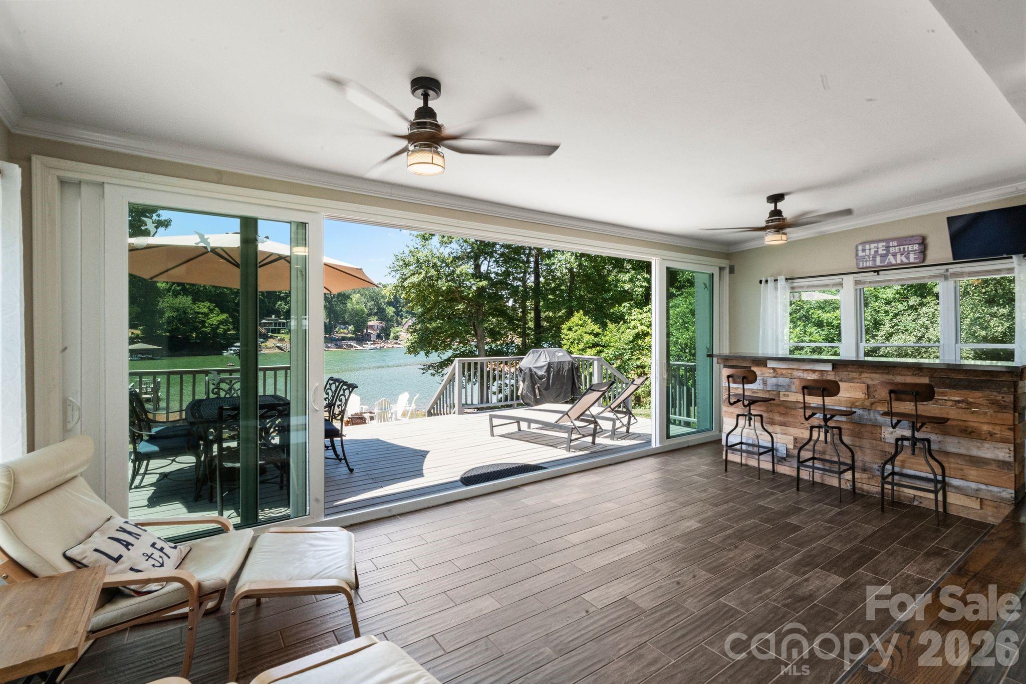 Large sliding glass doors offer lake views - 383 Sundown Road, Mooresville