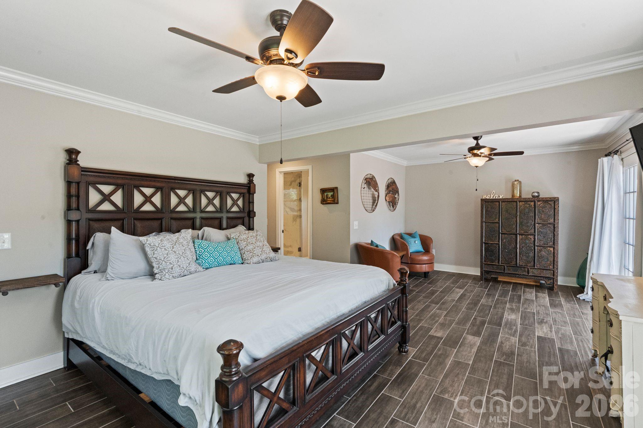 Spacious primary bedroom with sitting area, private bath, walk-in closet and 2 balconies - 383 Sundown Road, Mooresville