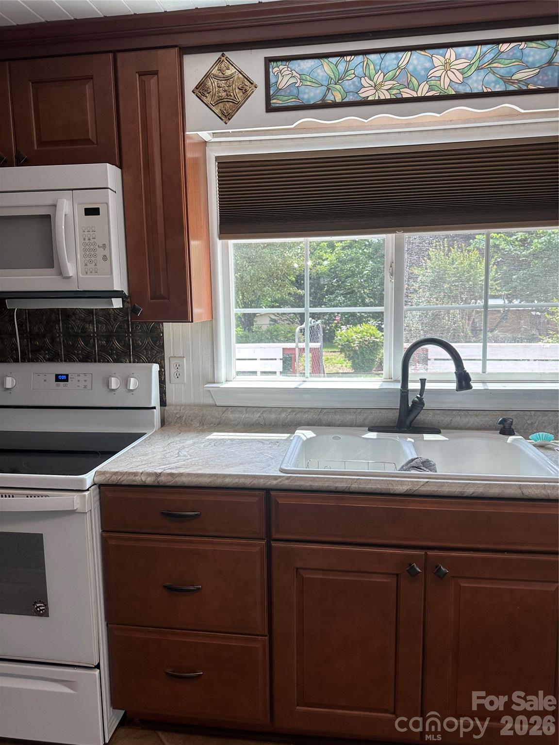 kitchen sink, nice cabinets, range with microwave hood. - 1407 N College Avenue, Newton