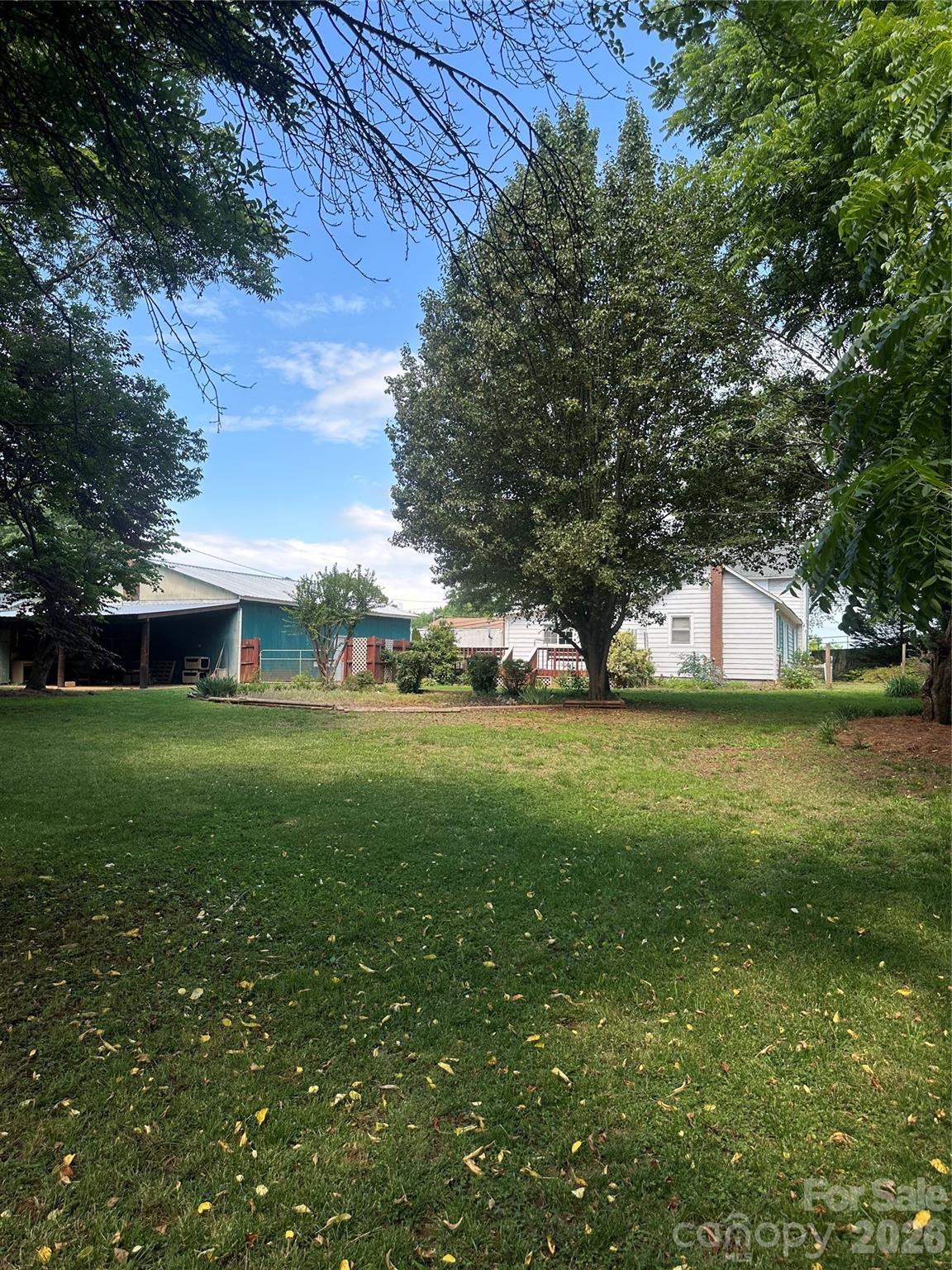 view from yard to back of house and shed behind garage. - 1407 N College Avenue, Newton
