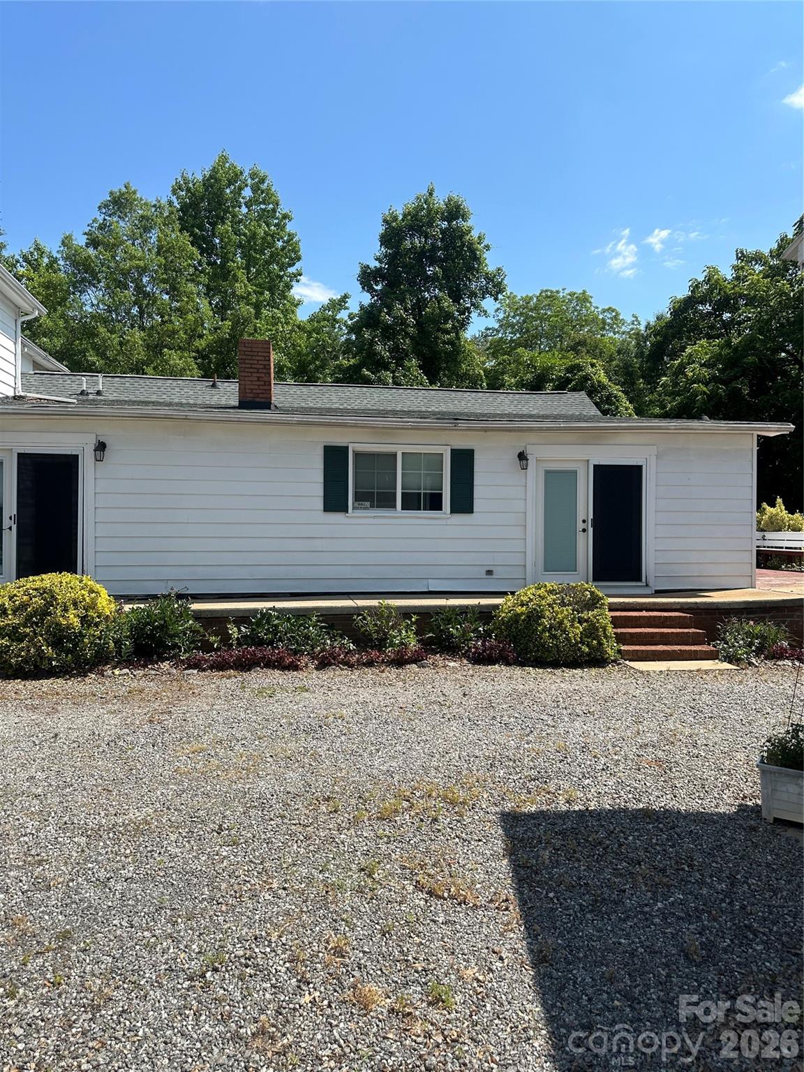 Large driveway and view of door going it to the kitchen. - 1407 N College Avenue, Newton